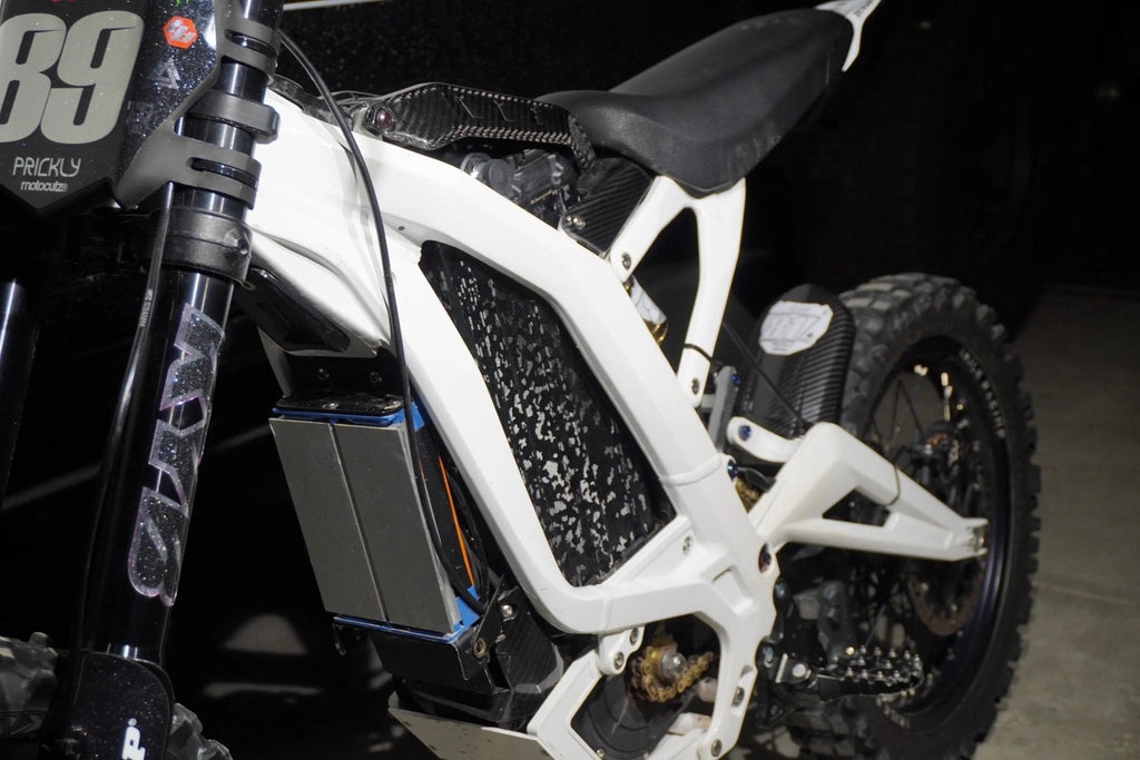MXwraps ShadowSlate black camouflage vinyl wrap on e-bike battery, showcasing sleek camouflage design and durable material.