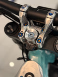 Set of four DevMoto direct mount riser bolts for motorcycle handlebars, shown in close-up detail.