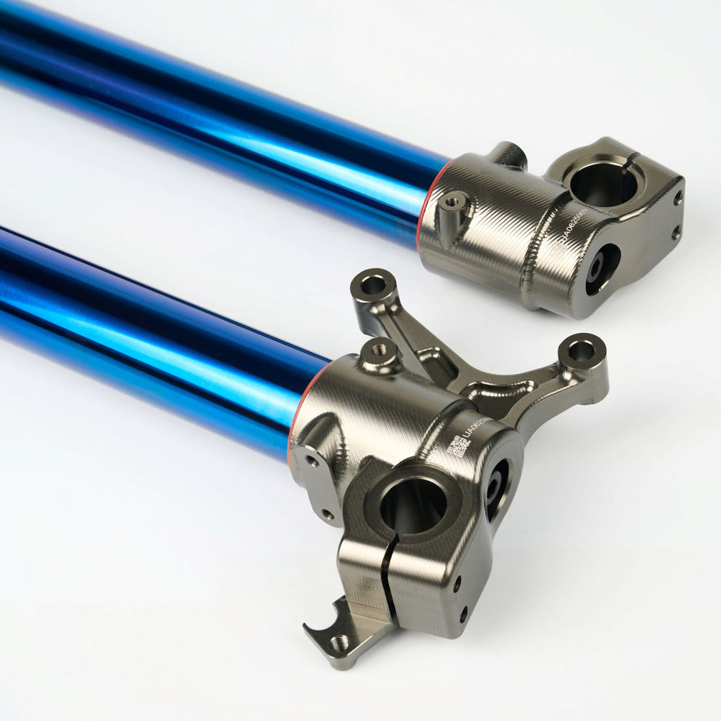 Modded Moto Co Pure Racing Surron Ultra/Talaria Komodo suspension forks with titanium lowers, shown from a side view.