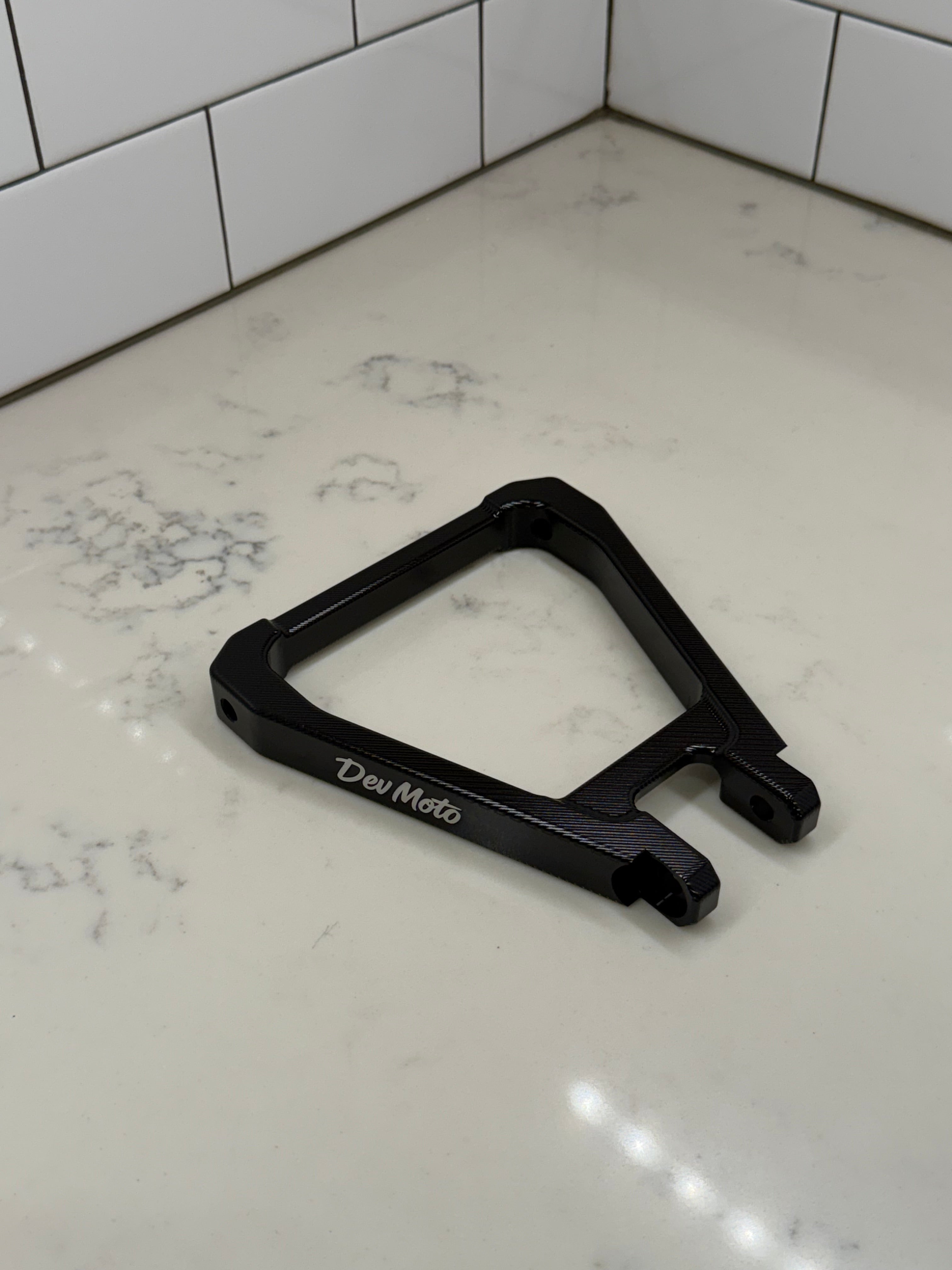 DevMoto E-Moto suspension triangle for electric motorcycles, showing the metal frame component with mounting points.