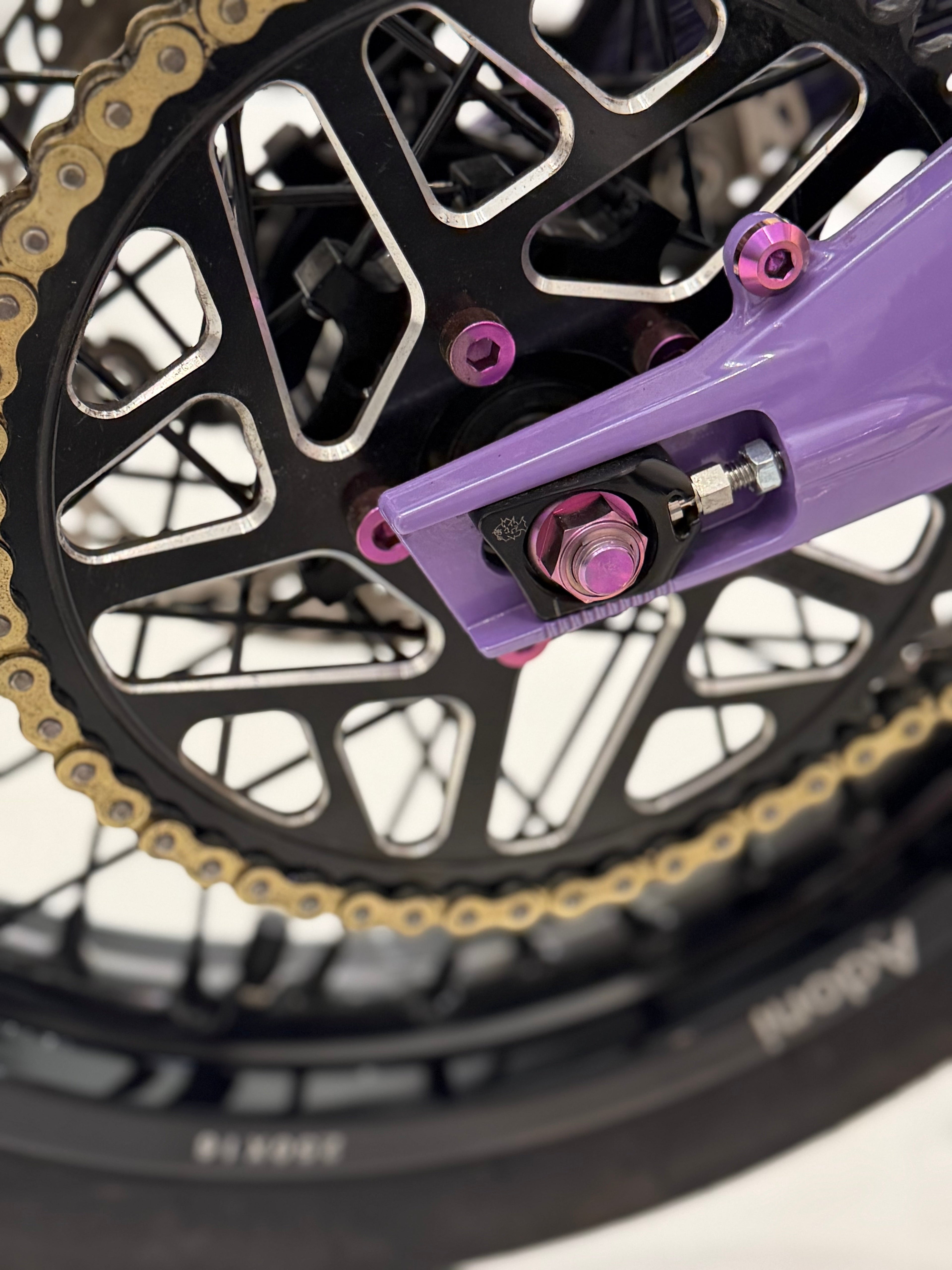 DevMoto All Emoto Sprocket Titanium Bolts shown in a close-up image, highlighting their lightweight, durable titanium construction.