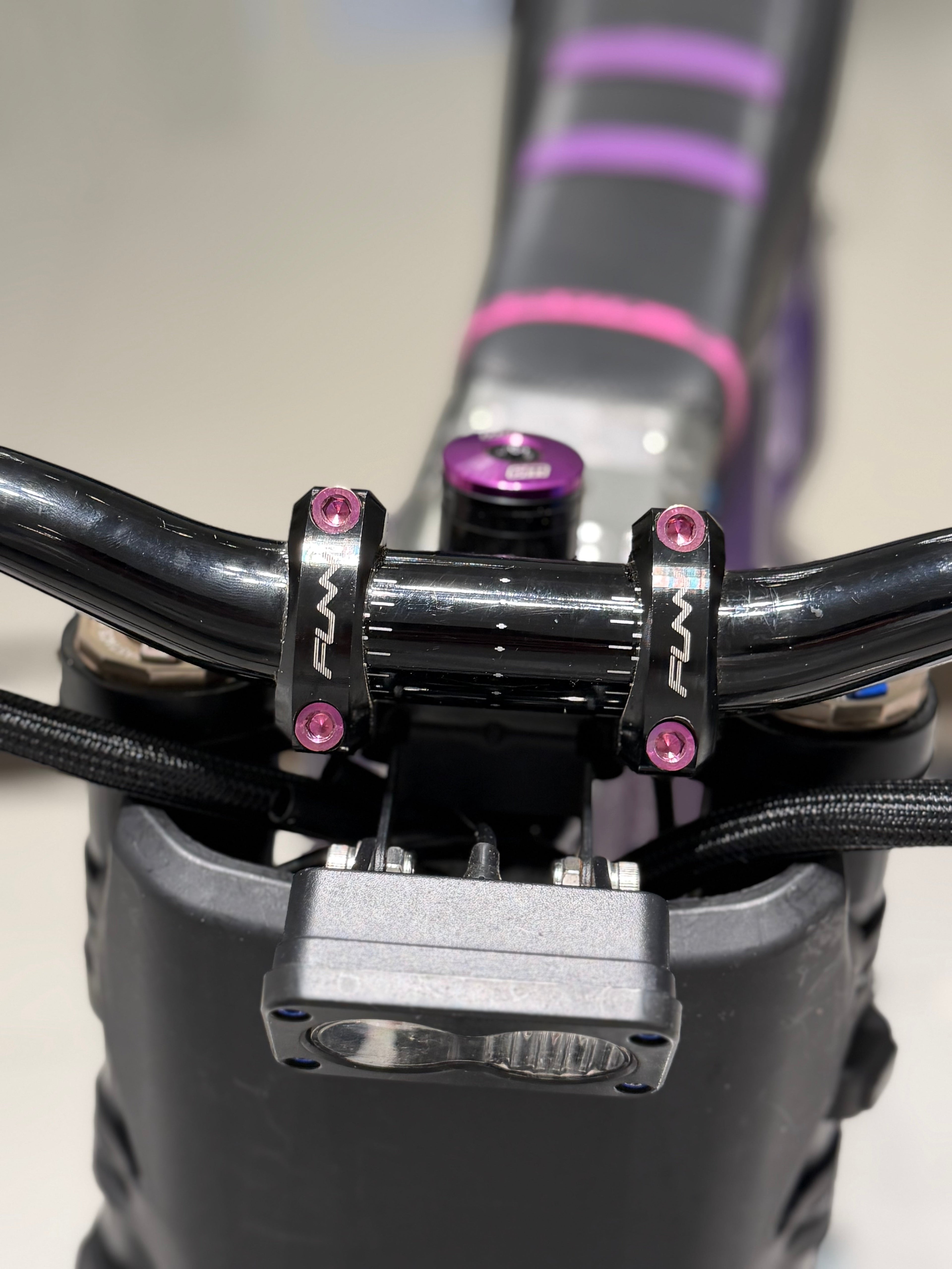 DevMoto direct mount titanium bolts for motorcycle, showing four lightweight, high-strength bolts with threaded ends.