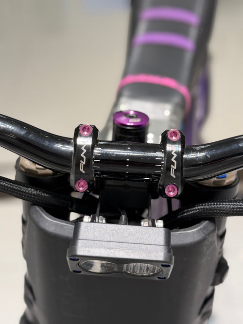 DevMoto direct mount titanium bolts for motorcycle, showing four lightweight, high-strength bolts with threaded ends.