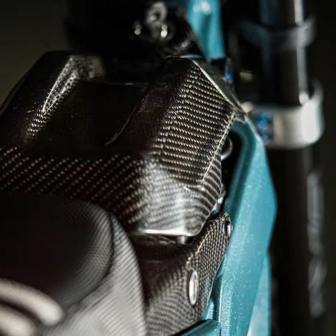 Modded Moto Co E-Ride Pro carbon fiber battery lid accessory, sleek black finish with precise fit for e-bike battery cover.