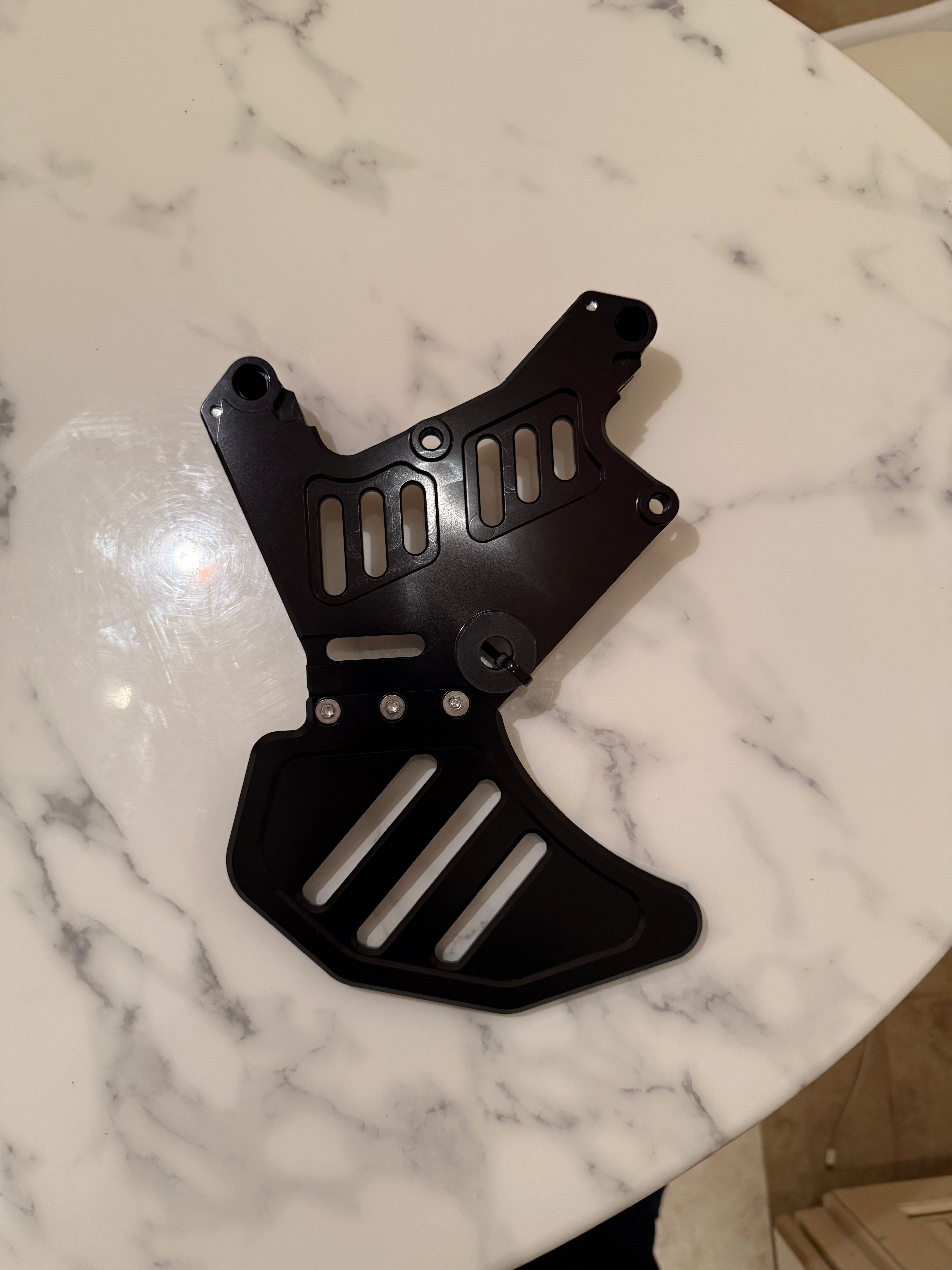Surgeracingco Talaria XXX footbrake pedal with textured surface and sleek black finish for motorcycle control.