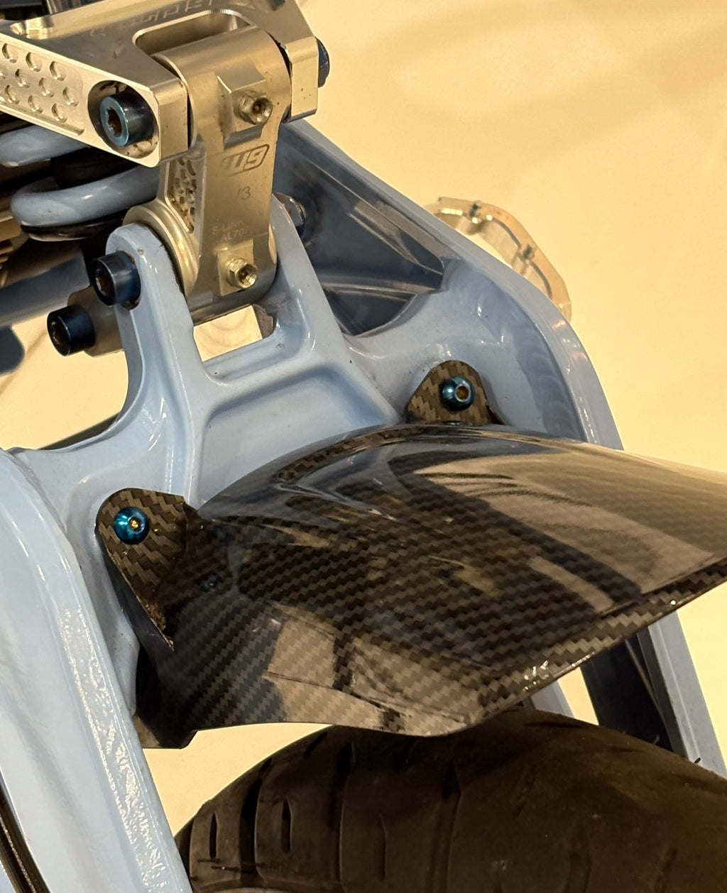 DevMoto rear fender titanium bolts set of 2, showcasing sleek, lightweight fasteners with a polished finish on a neutral background.