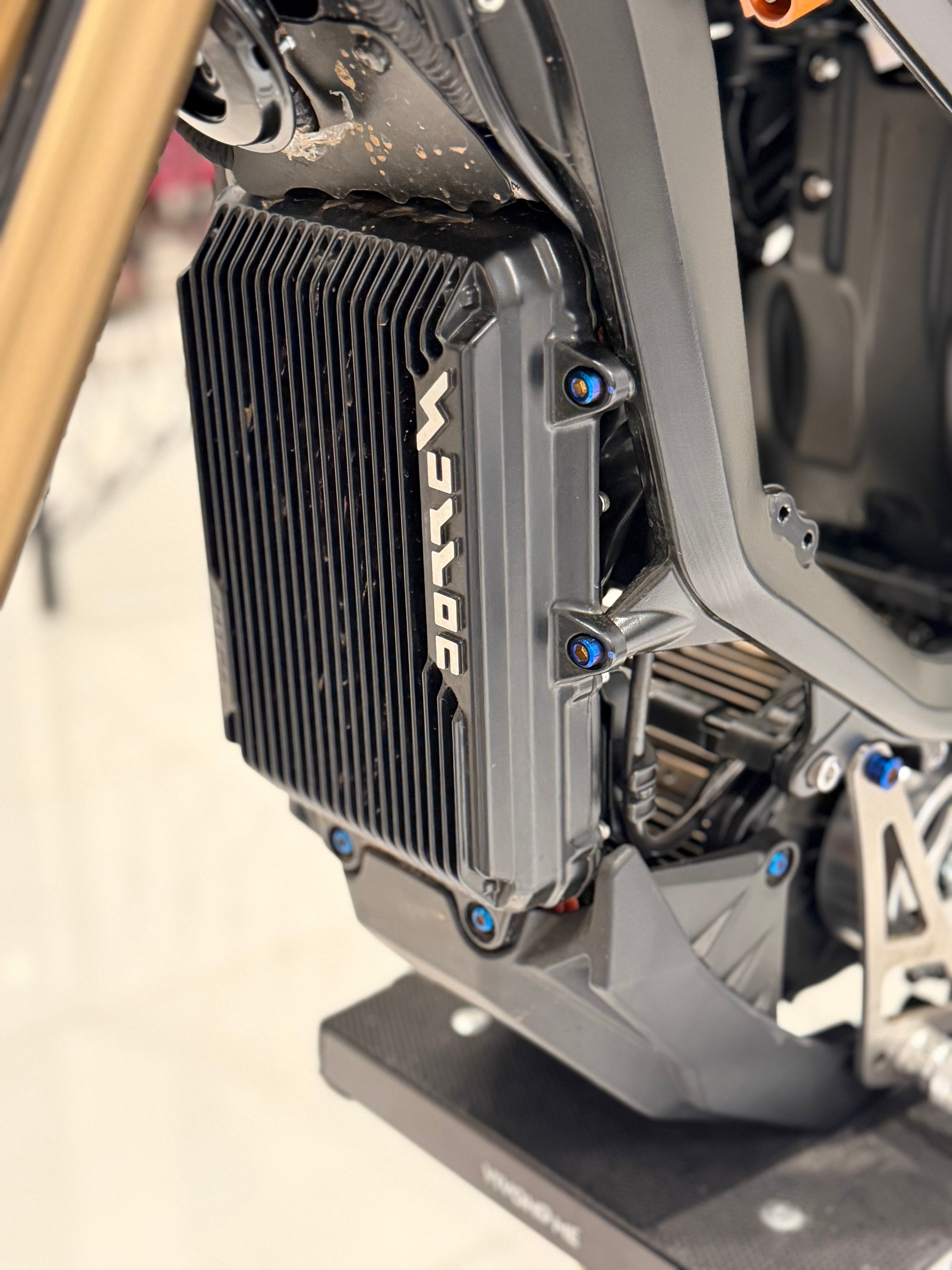 Set of four DevMoto Ultra Bee Controller mounting bolts for E-Moto, shown in metallic finish on a neutral background.