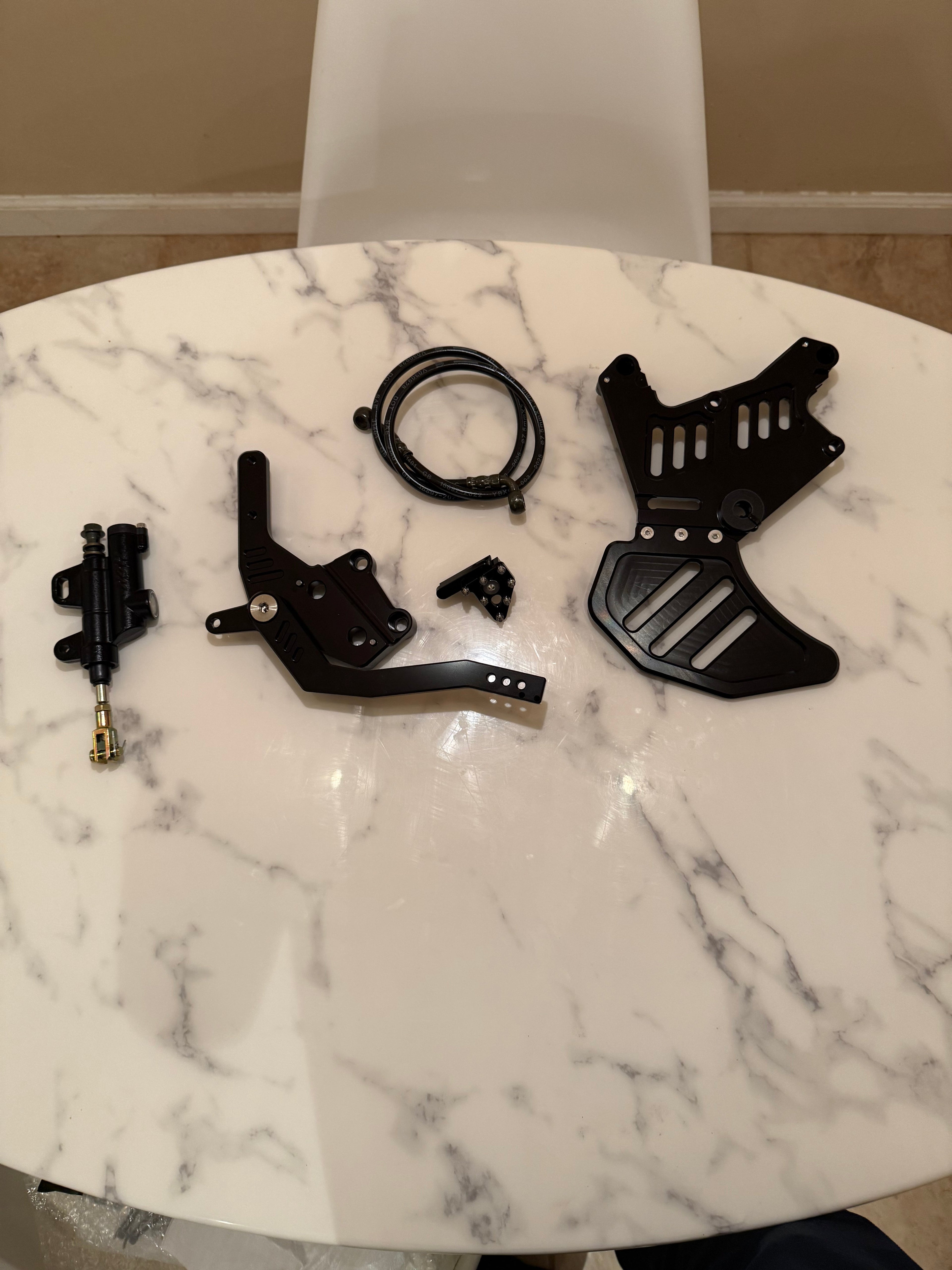 Surge Racing Co Talaria XXX footbrake lever with detailed metal construction and ergonomic design for motorcycle braking system.
