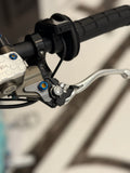 DevMoto Ultra Bee Brake Pivot Titanium Bolt, lightweight and durable bicycle brake component, shown in close-up detail.