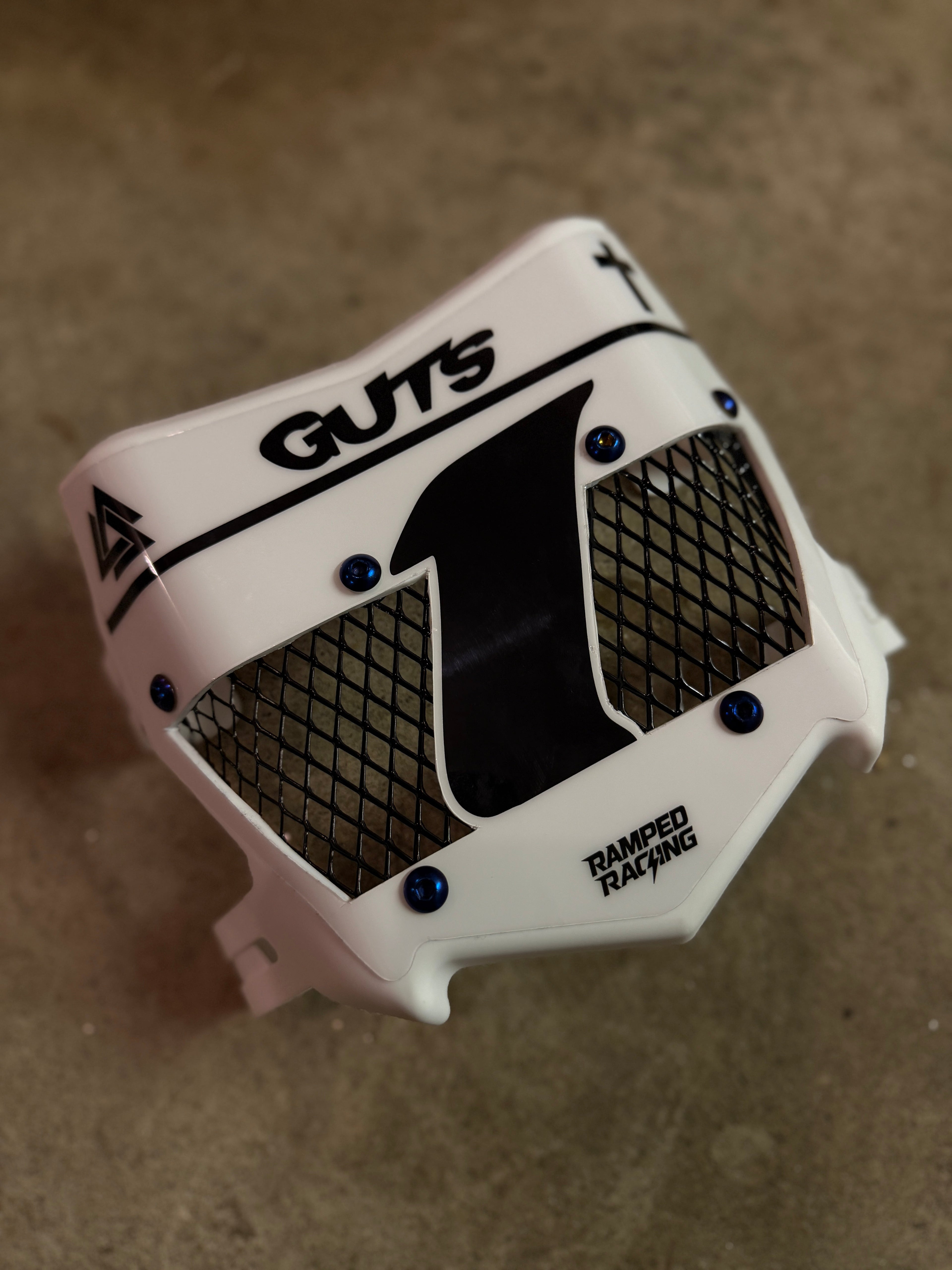 Ramped Racing Titanium Vented Plate in white, lightweight motorcycle racing part with vented design for improved airflow.