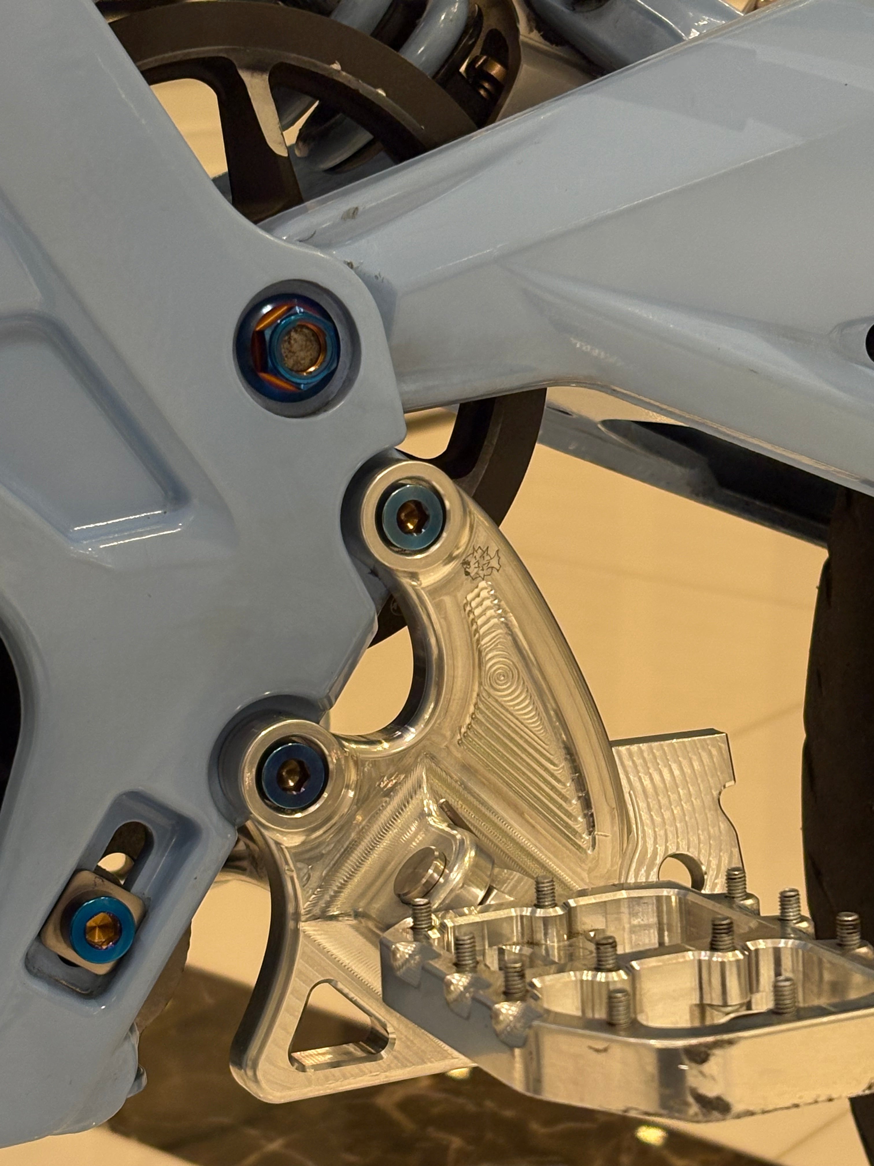 Set of four DevMoto All Emoto Peg Bracket Titanium Bolts for motorcycle footpegs and accessories.