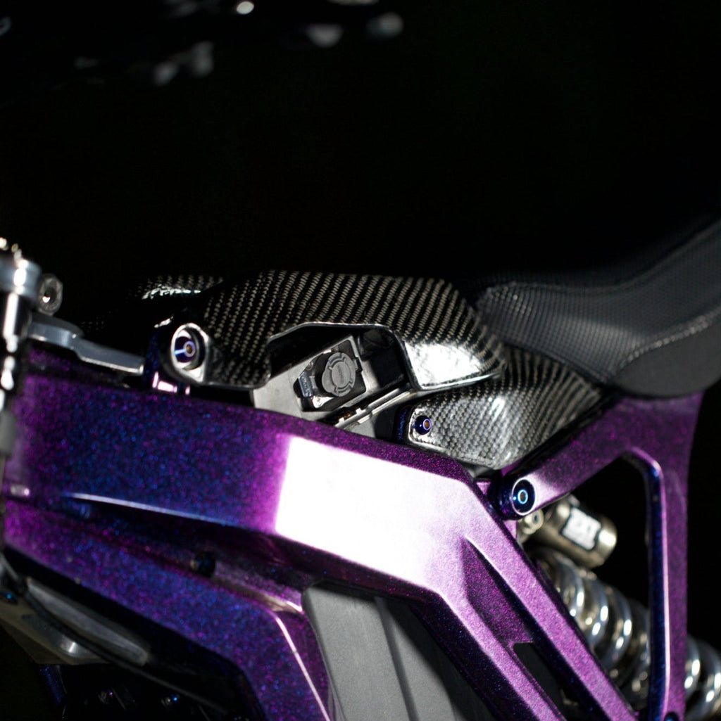 Modded Moto Co E-Ride Pro carbon fiber battery lid accessory, lightweight and durable for e-bike battery protection.