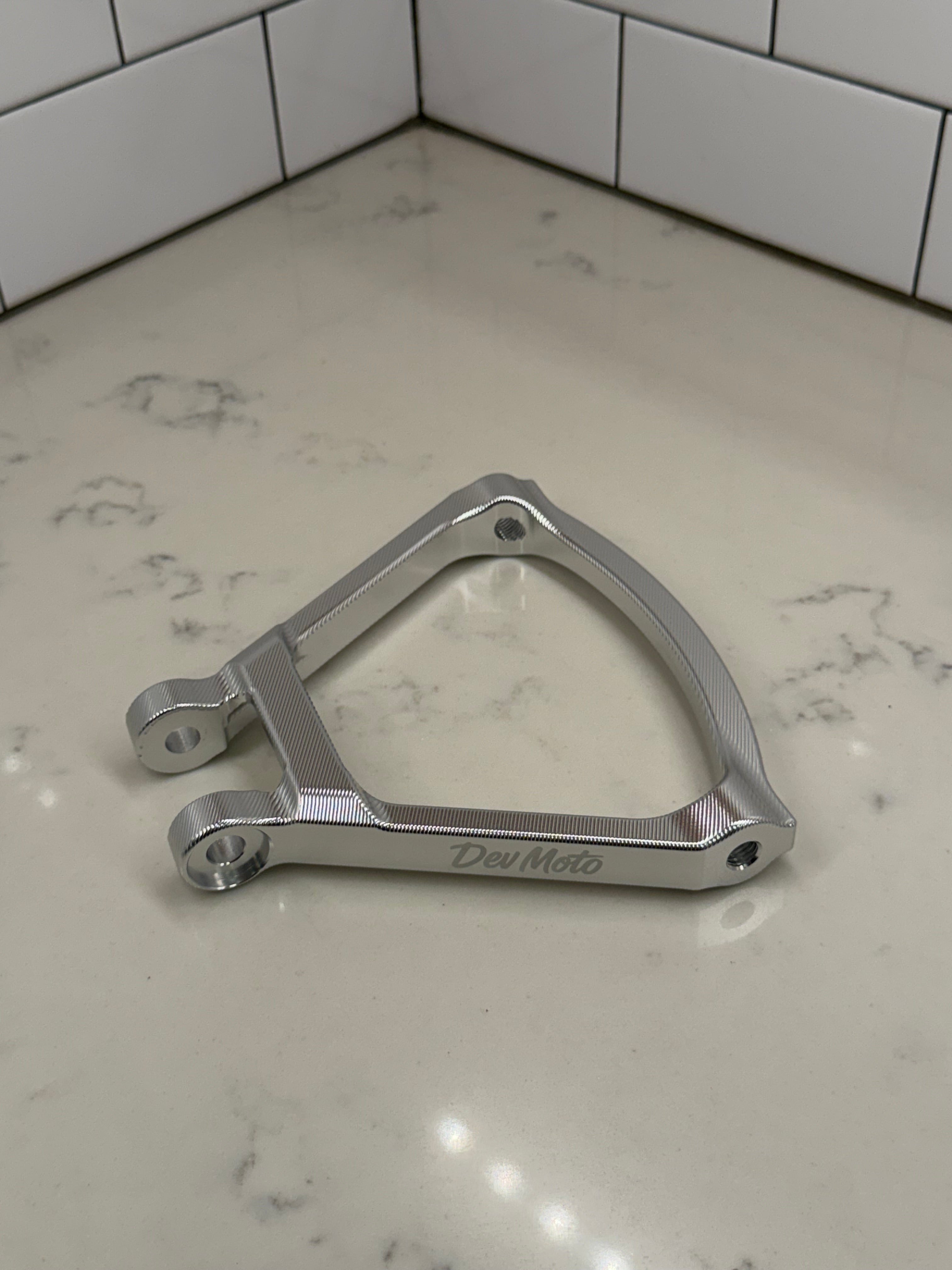 DevMoto E-Moto suspension triangle for electric motorcycle, showing the sturdy metal frame and mounting points.