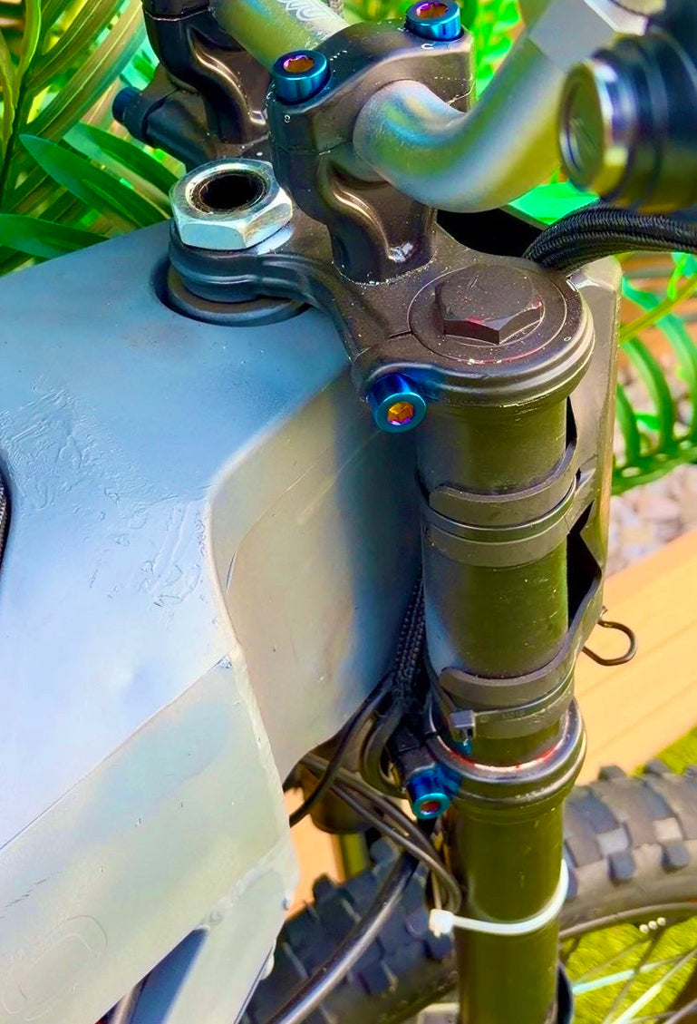 DevMoto Tuttio and Yozma triple clamp titanium bolts set of 4, showing sturdy, lightweight bolts with a sleek metallic finish.