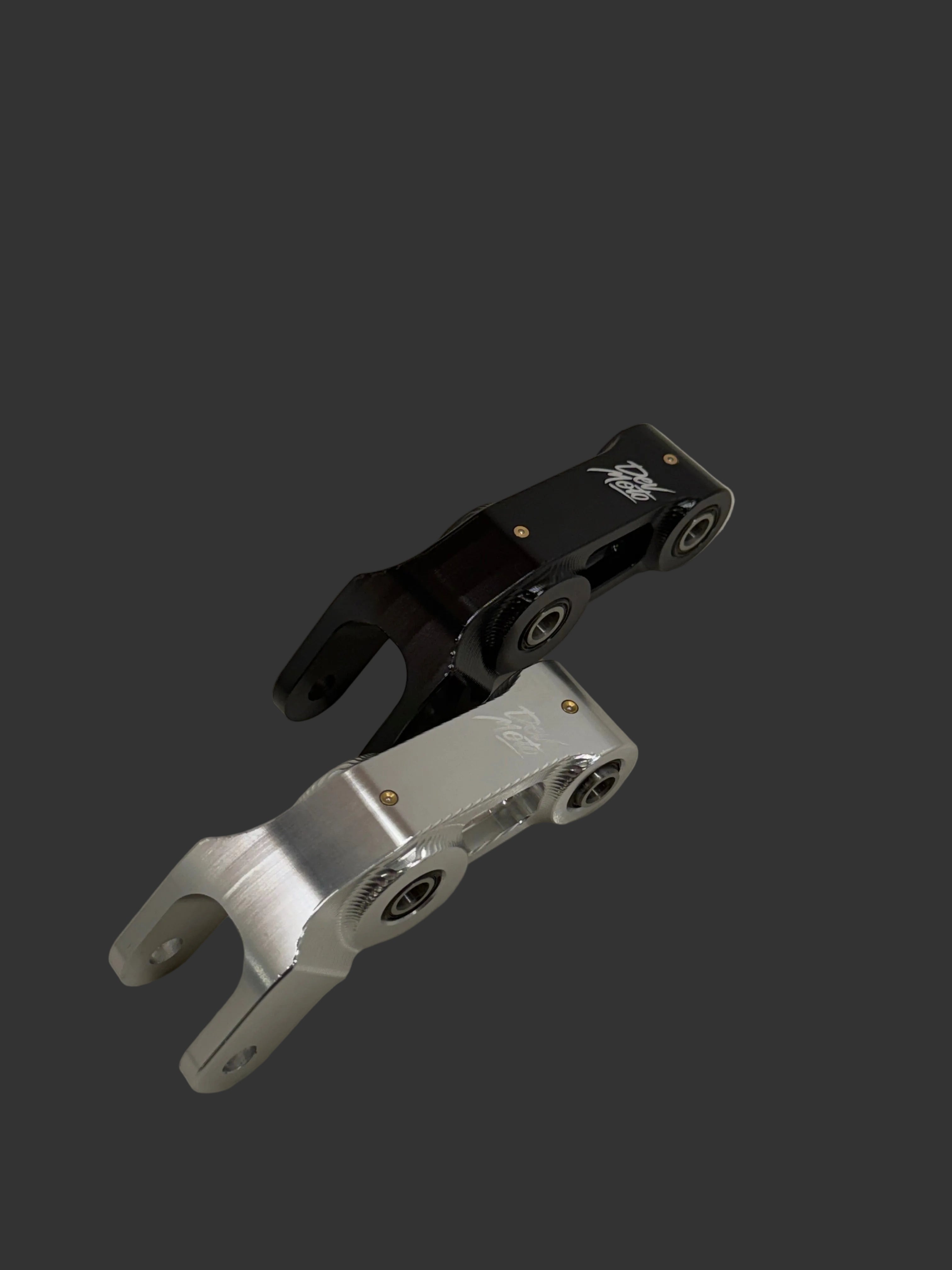 DevMoto E-Moto suspension linkage showing metal components and mounting points for electric motorcycle suspension upgrade