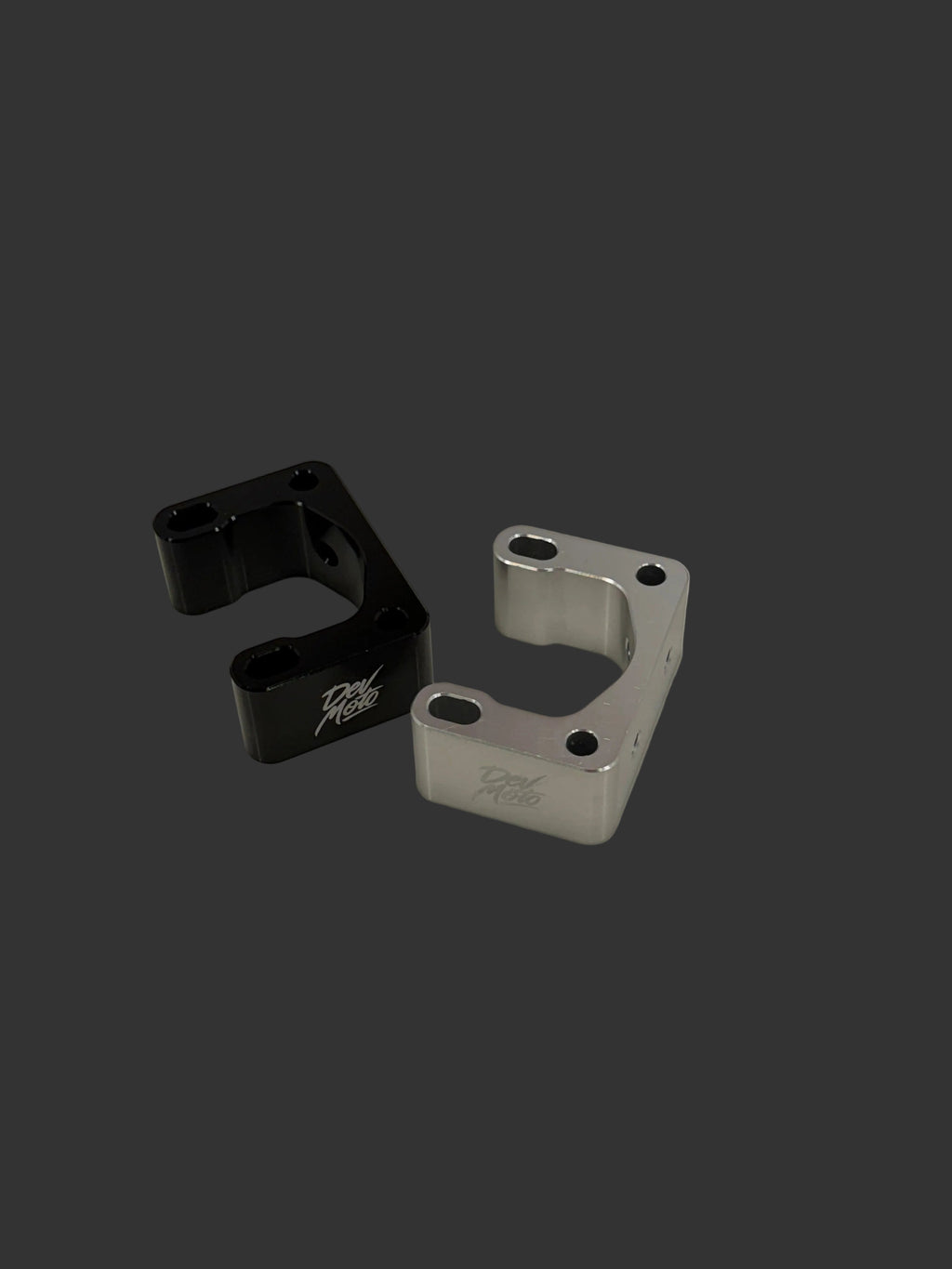 DevMoto direct mount riser for motorcycle handlebars, showcasing the sturdy aluminum construction and ergonomic design.