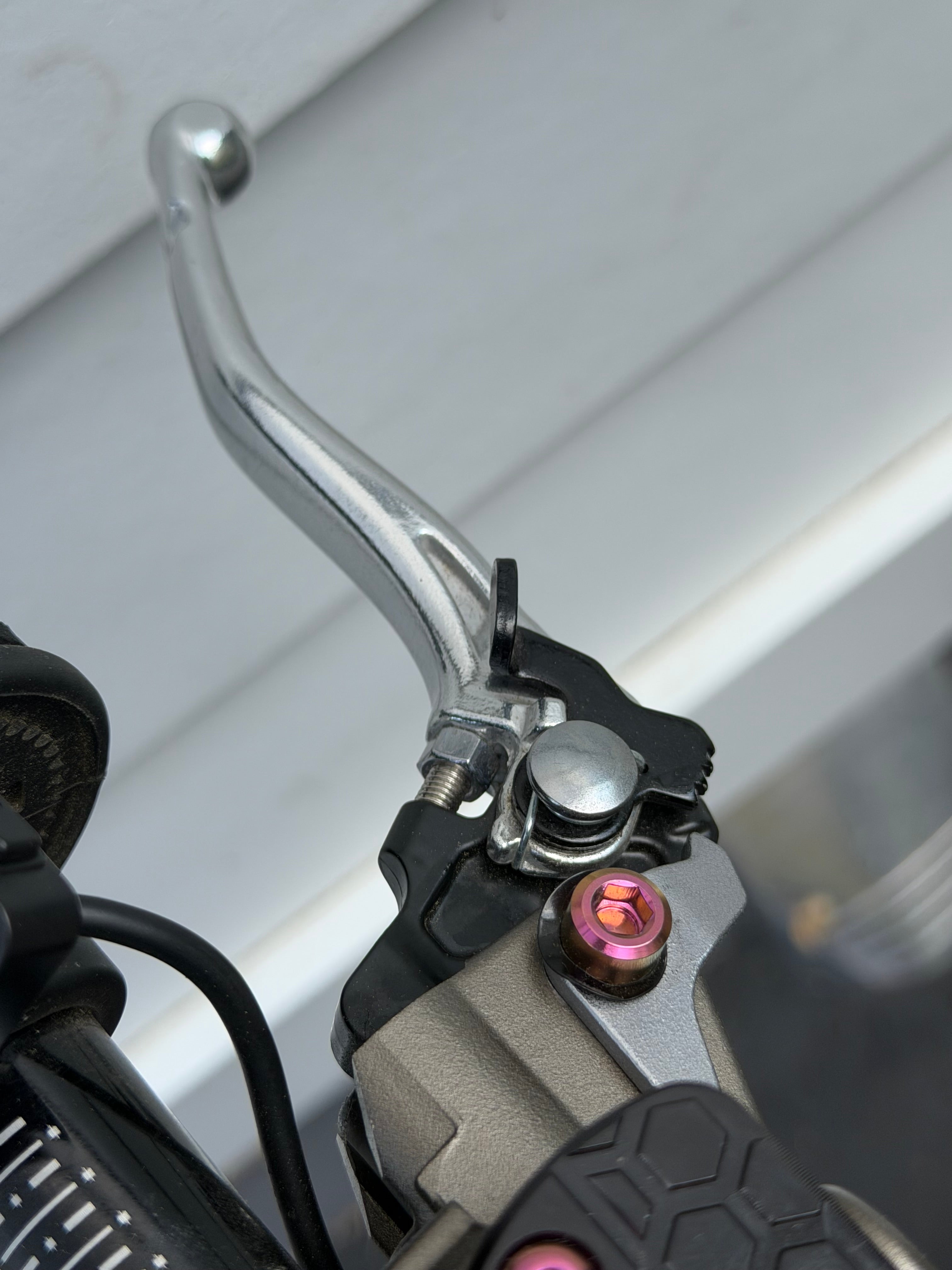DevMoto Ultra Bee Brake Pivot Titanium Bolt, lightweight and durable bike component, shown in close-up on a clean background.