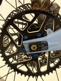 DevMoto All Emoto Sprocket Titanium Bolts installed on a motorcycle sprocket, showcasing lightweight and durable titanium construction.