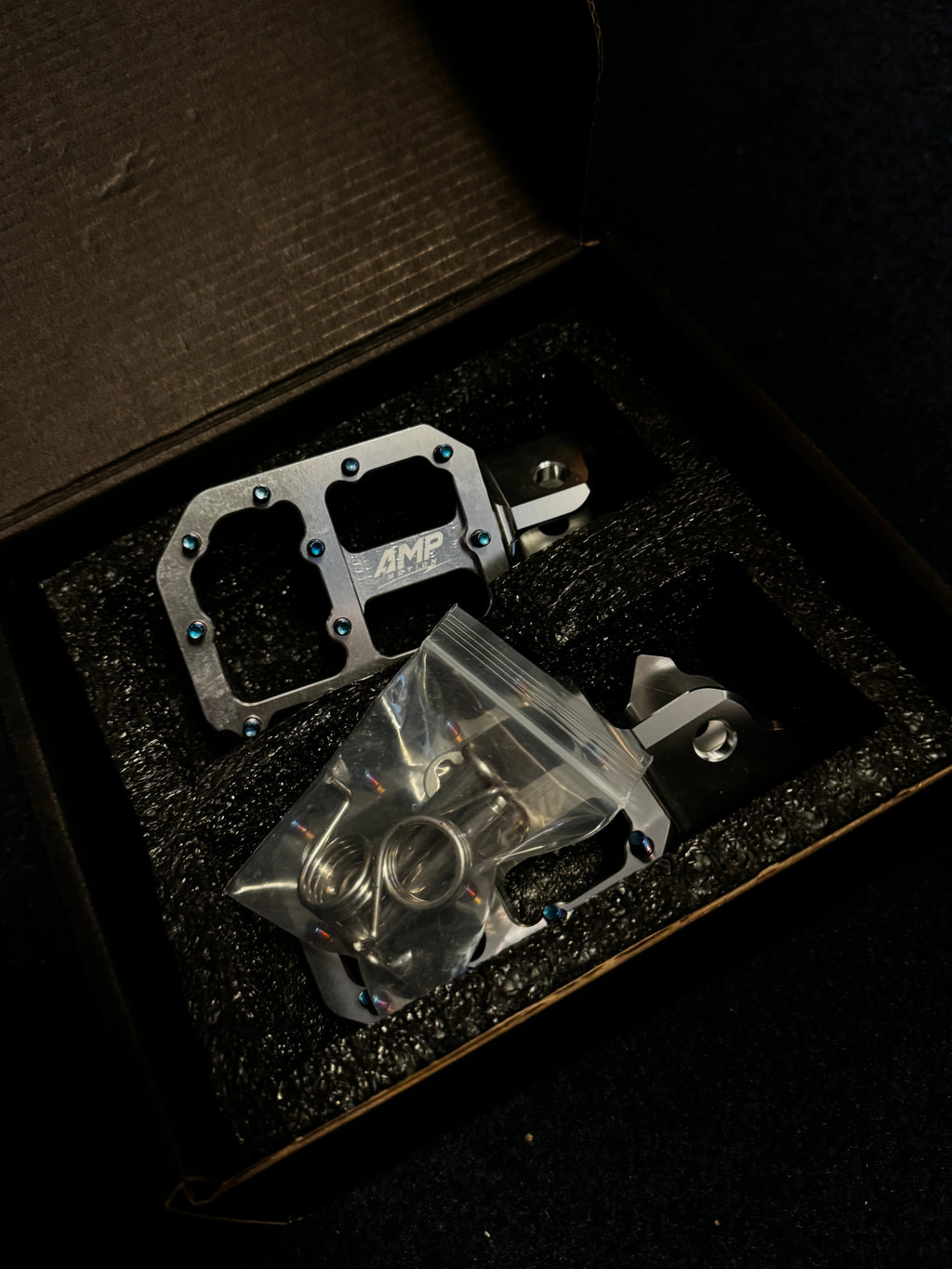 Amp Motion aluminum pegs for bikes, showcasing lightweight, durable metal pegs designed for bike customization and riding.