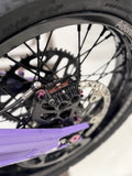 DevMoto titanium caliper mount bolts displayed, showcasing durable, lightweight fasteners for motorcycle brake calipers.