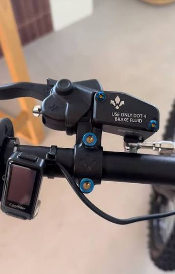 DevMoto Formula Brake Mount titanium bolts shown in the image, featuring lightweight, durable titanium construction for bike braking systems.