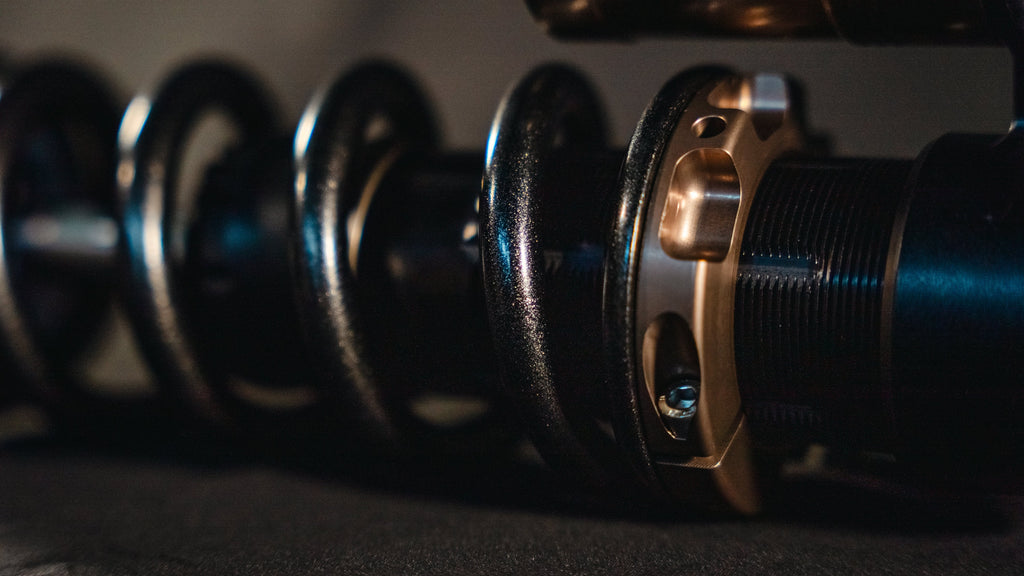Modded Moto Co EXT REA MX Shock – Ultra Bee for motocross bikes, showing the shock absorber with mounting hardware and branding details.