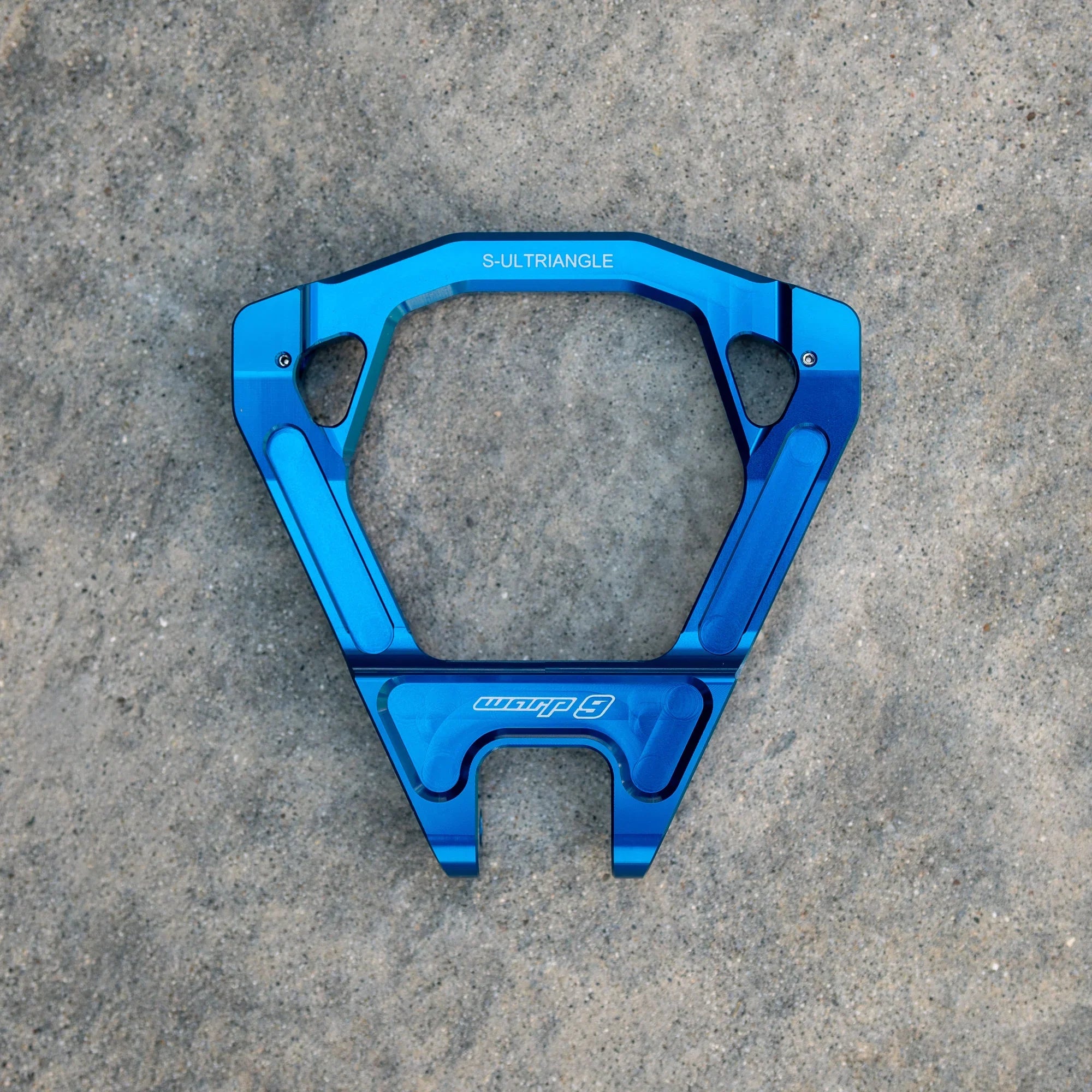 Modded Moto Co Warp 9 Surron Ultra Bee triple clamps and linkage assembly, showcasing precision-machined black metal components.