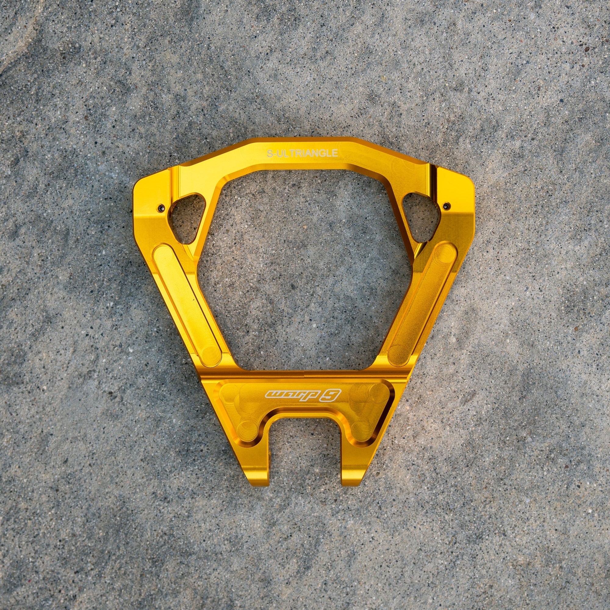 Warp 9 Surron Ultra Bee triple clamps and linkage from Modded Moto Co, showing polished metal components on a white background.