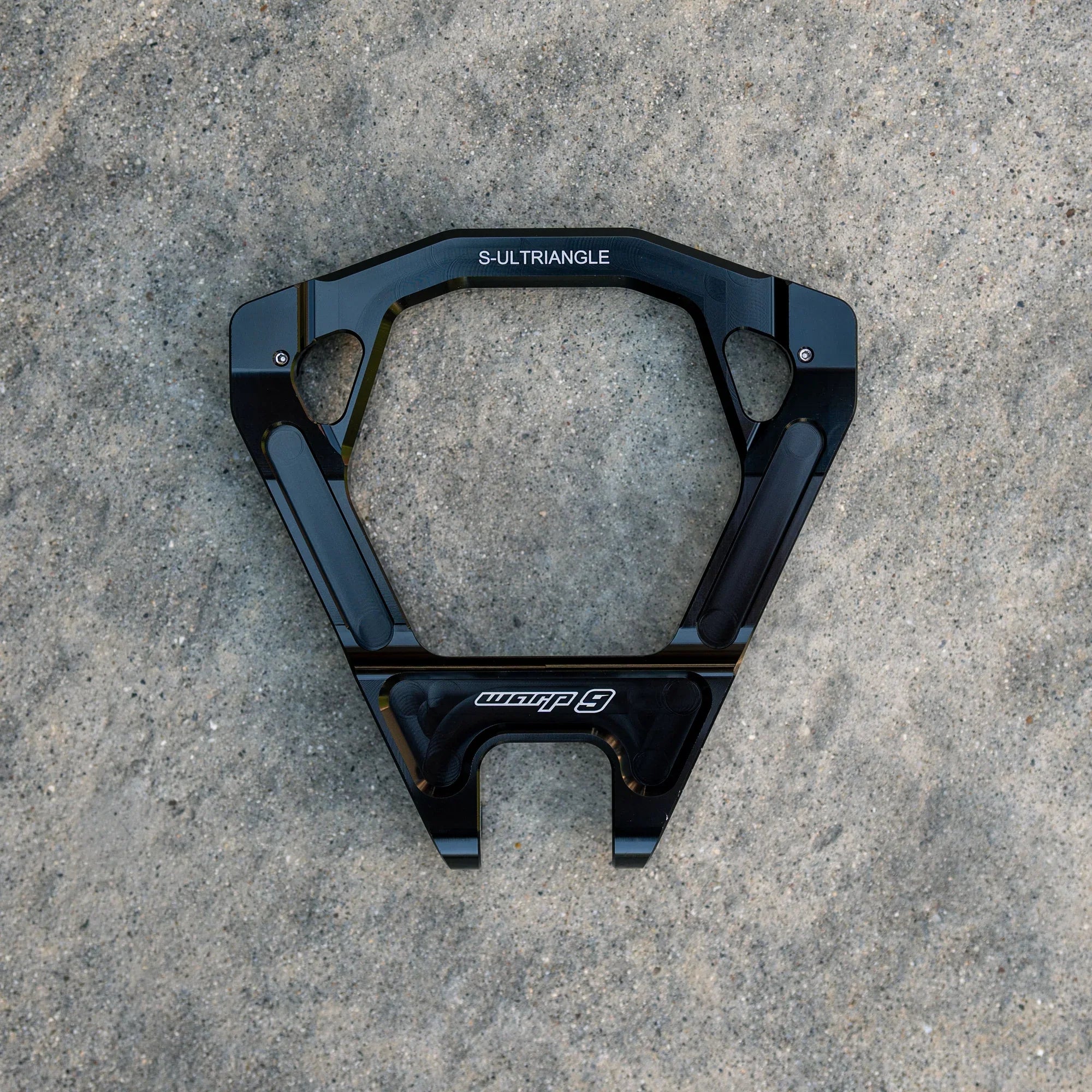 Modded Moto Co Warp 9 Surron Ultra Bee triple clamps and linkage, showcasing durable metal components and precise machining.