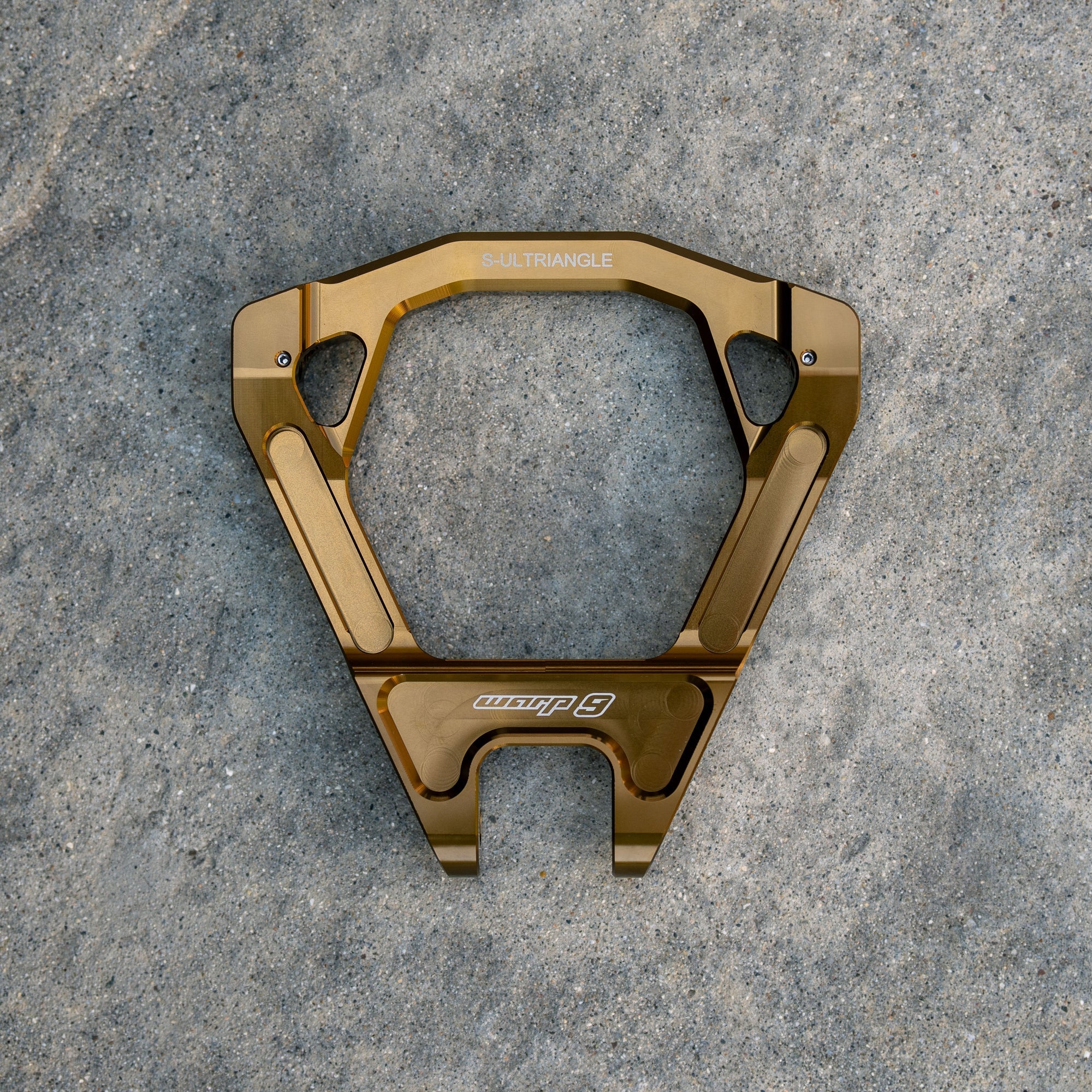 Modded Moto Co Warp 9 Surron Ultra Bee triple clamps and linkage installed on a bike, showcasing upgraded motorcycle components.