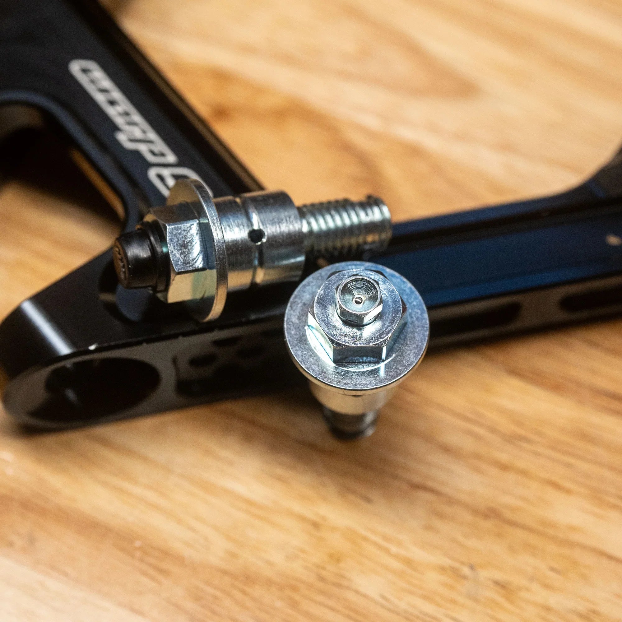 Modded Moto Co Warp 9 Surron Ultra Bee triple clamps and linkage installed on a bike, showcasing their sturdy design and precise fit.