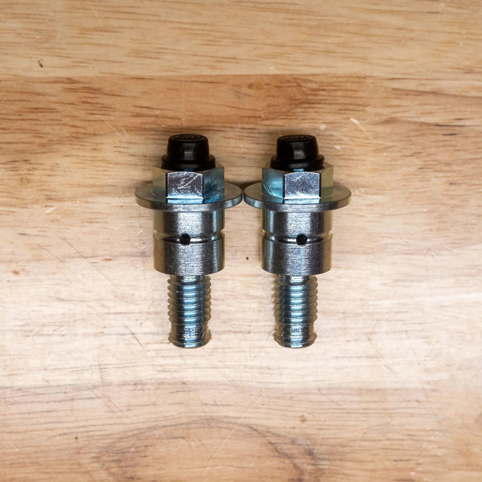 Modded Moto Co Warp 9 Surron Ultra Bee triple clamps and linkage installed, showcasing precision machined components for enhanced performance.