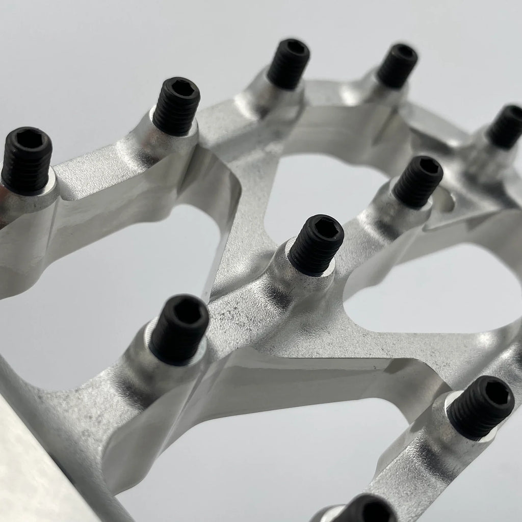 Titanium bolts for motorcycle foot pegs, Warp 9 Titanium Elite Foot Peg Screws by Modded Moto Co, shown in close-up.