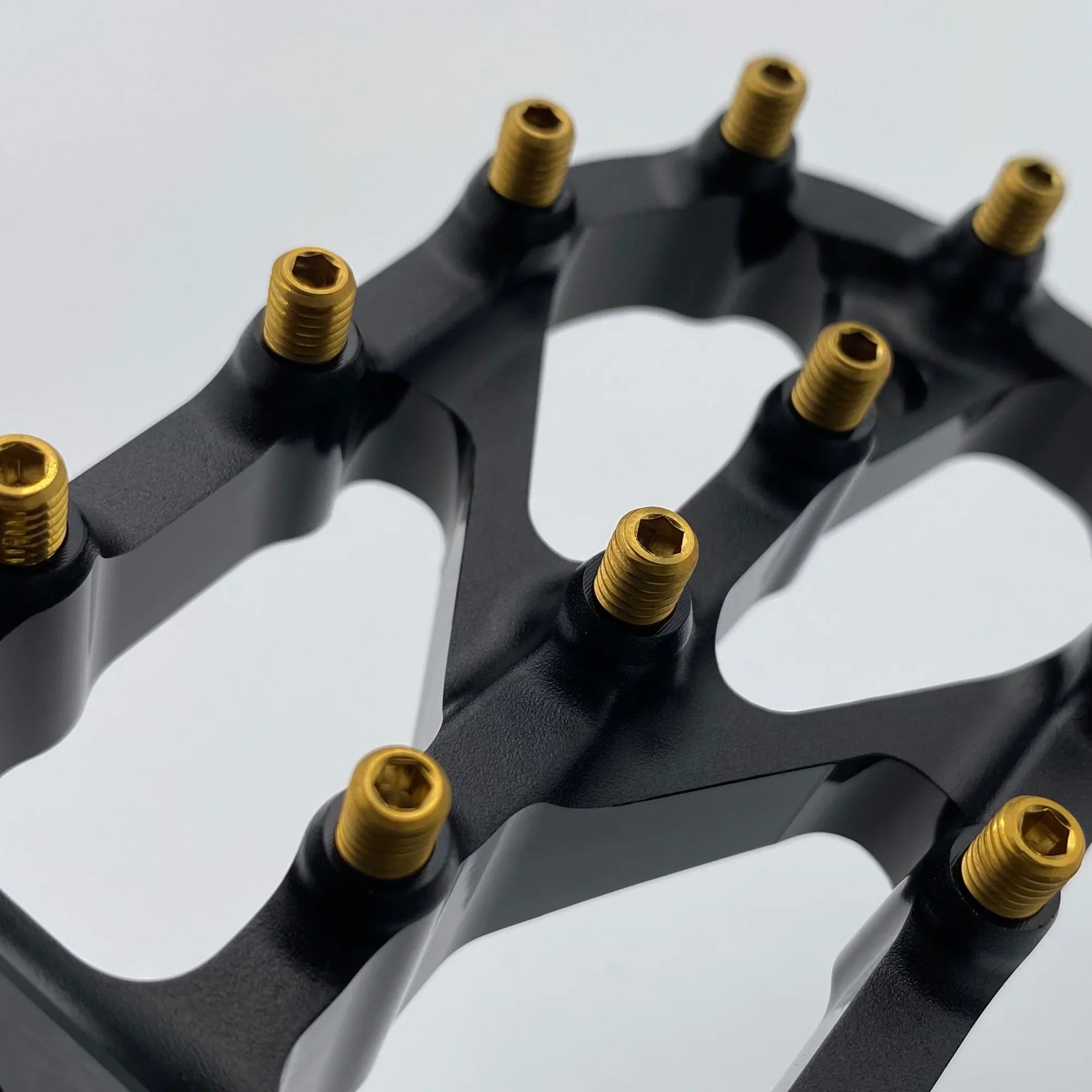 Modded Moto Co Warp 9 Titanium Elite foot peg screws, durable titanium bolts with a sleek finish, designed for motorcycle foot pegs.
