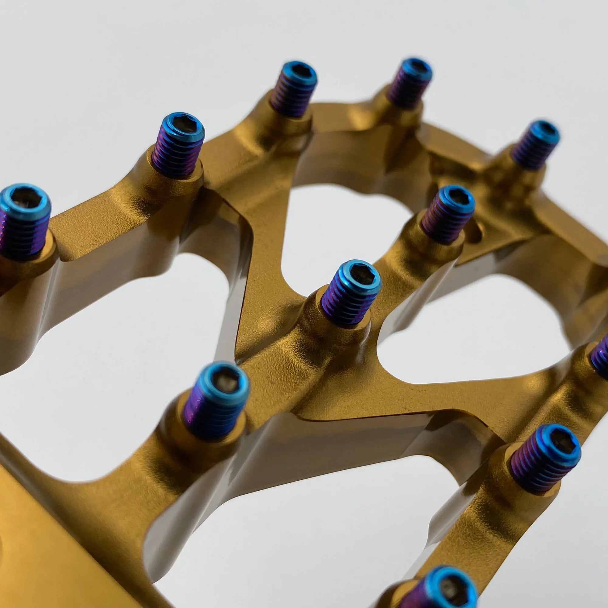 Modded Moto Co Warp 9 Titanium Elite foot peg screws, durable titanium bolts for motorcycle foot pegs, shown in close-up.