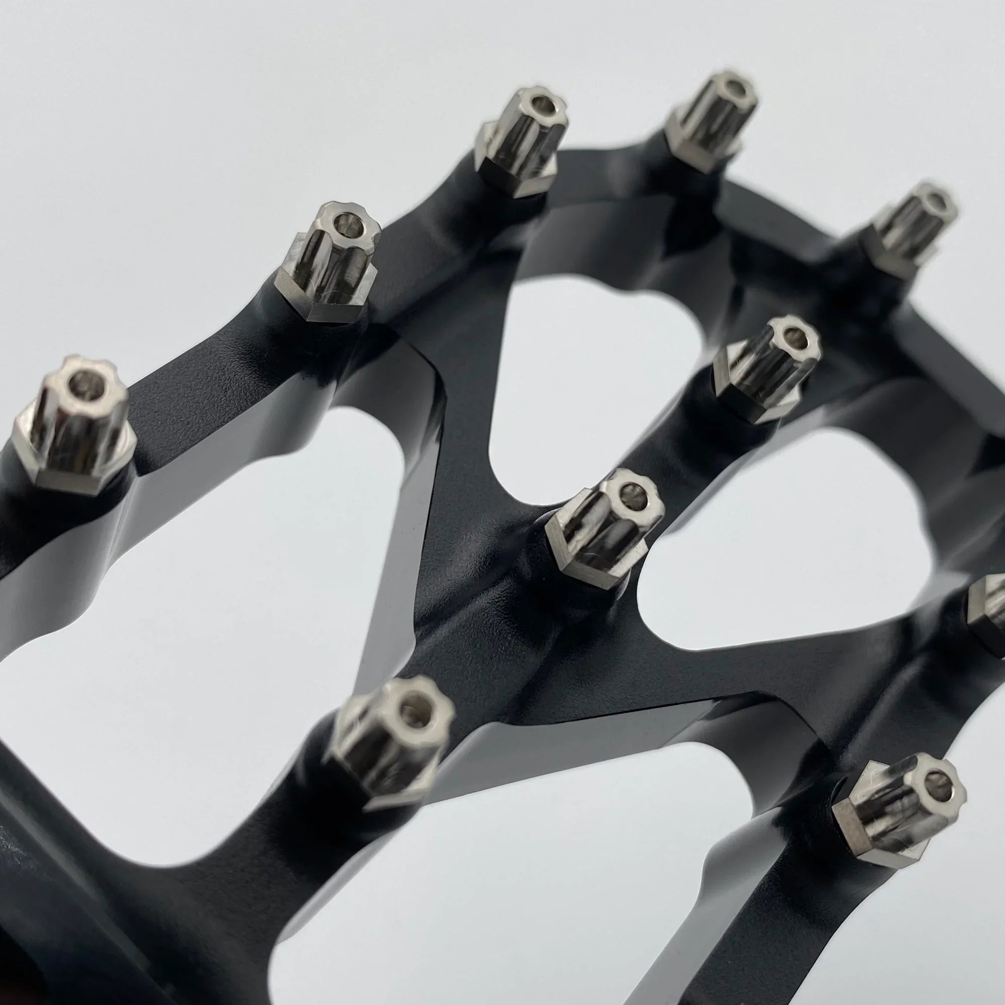 Titanium bolts from Modded Moto Co featuring Warp 9 Titanium Elite Foot Peg Screws with EP Torx heads, shown in close-up.