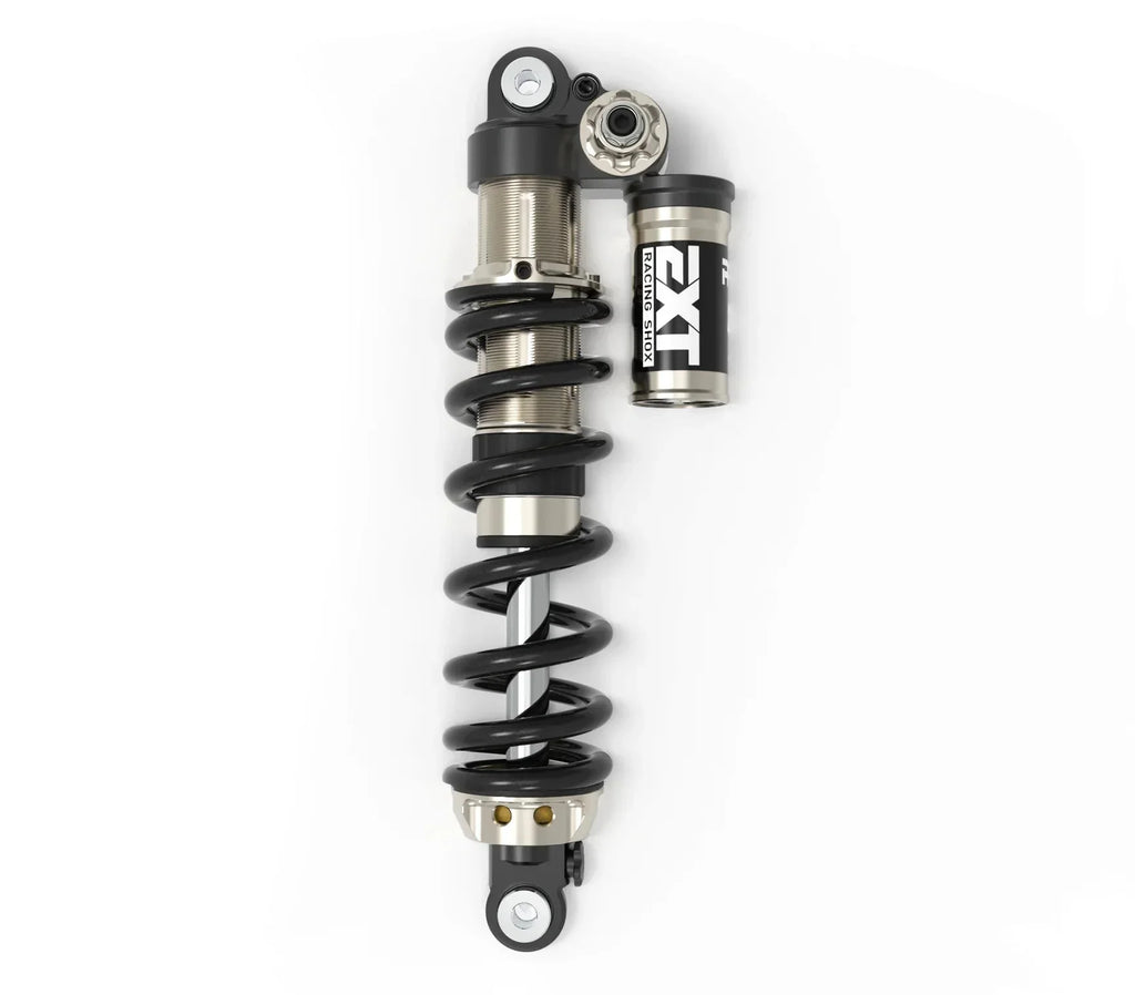Modded Moto Co EXT Arma MX rear shock absorber for motocross bikes, showcasing its sturdy build and mounting points.