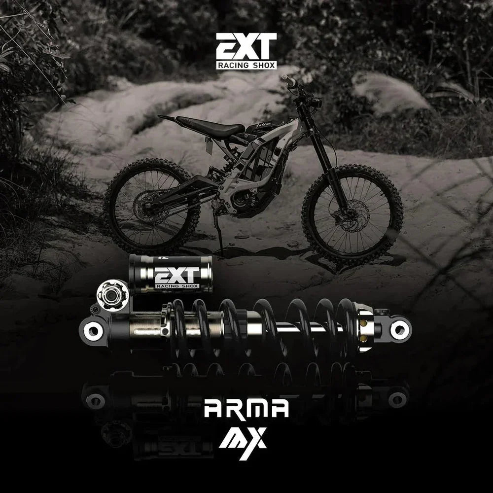 Modded Moto Co EXT Arma MX rear shock absorber showing its coil spring and mounting hardware on a motorcycle suspension system.