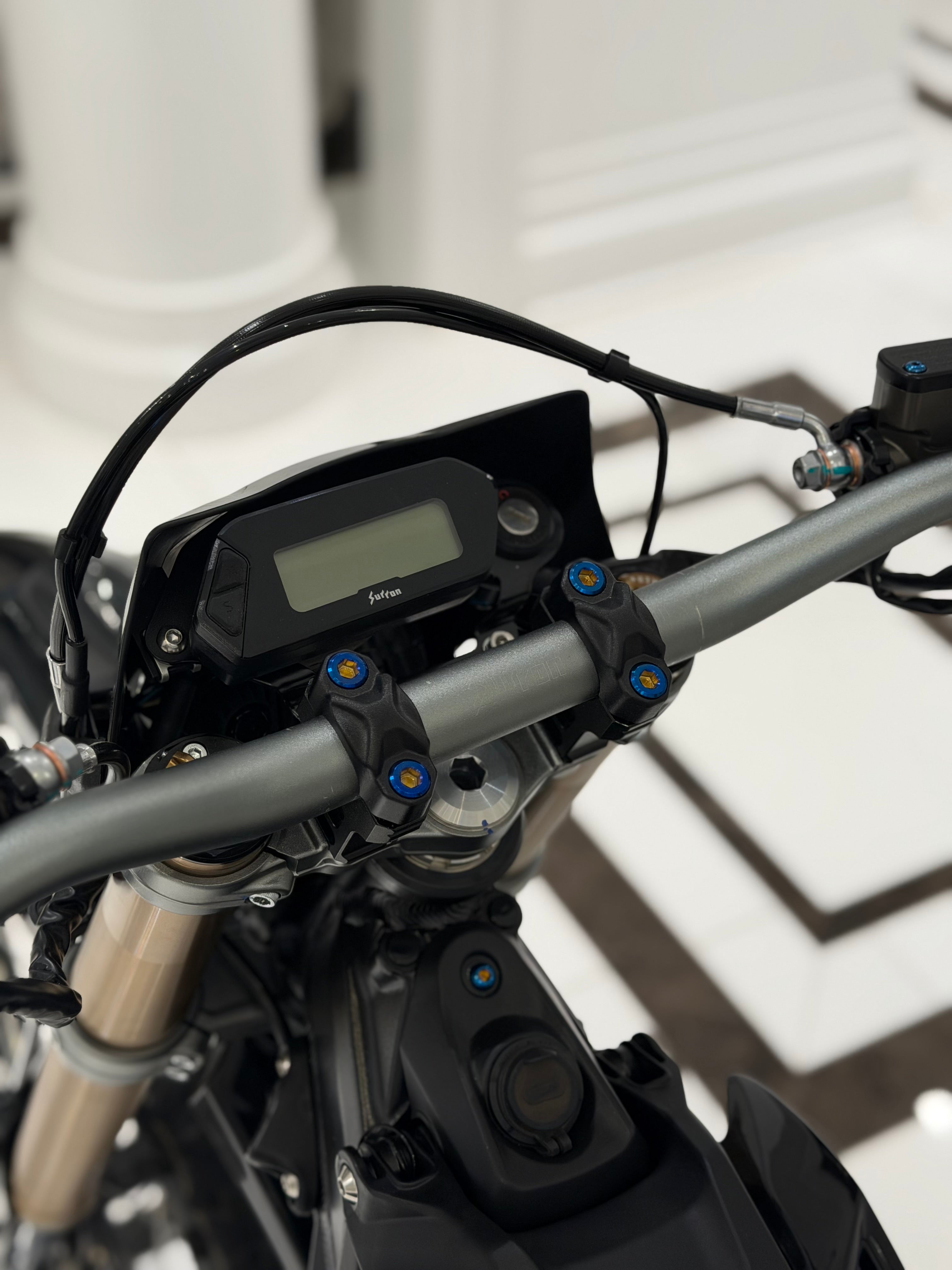Set of four DevMoto Ultra Bee Direct Mount Titanium Bolts, with shiny metallic finish and precise threading.