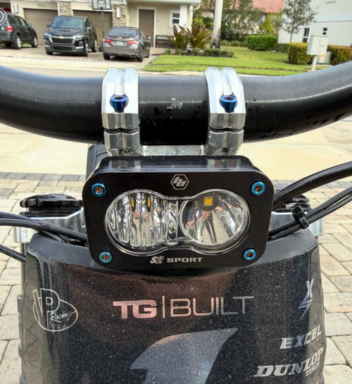 DevMoto Baja Titanium bolts set of 4, lightweight and durable fasteners for motorcycle applications, shown in a close-up view.