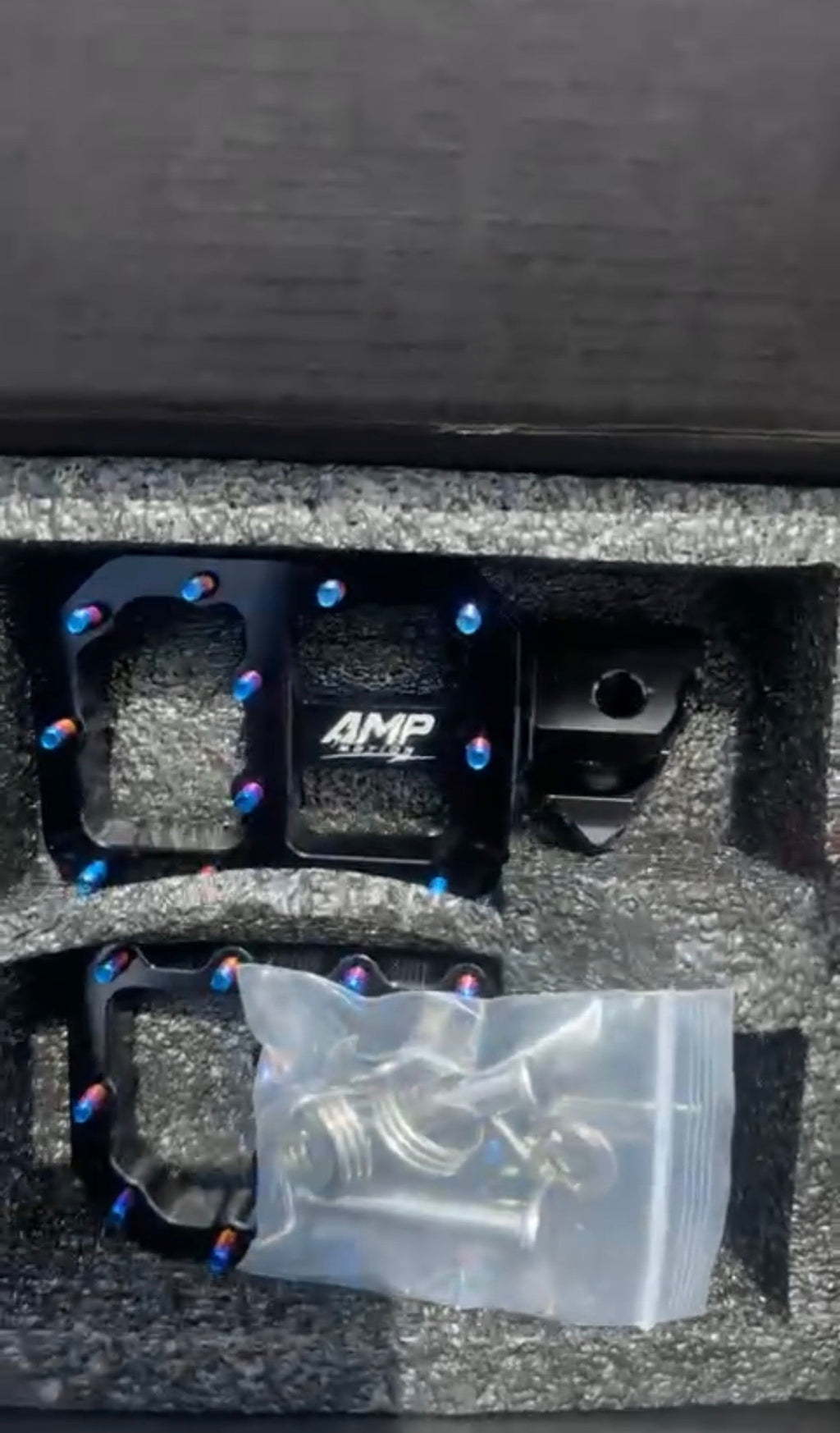 Amp Motion aluminum pegs for bicycles, shown in a full view with a sleek metallic finish and mounting details.