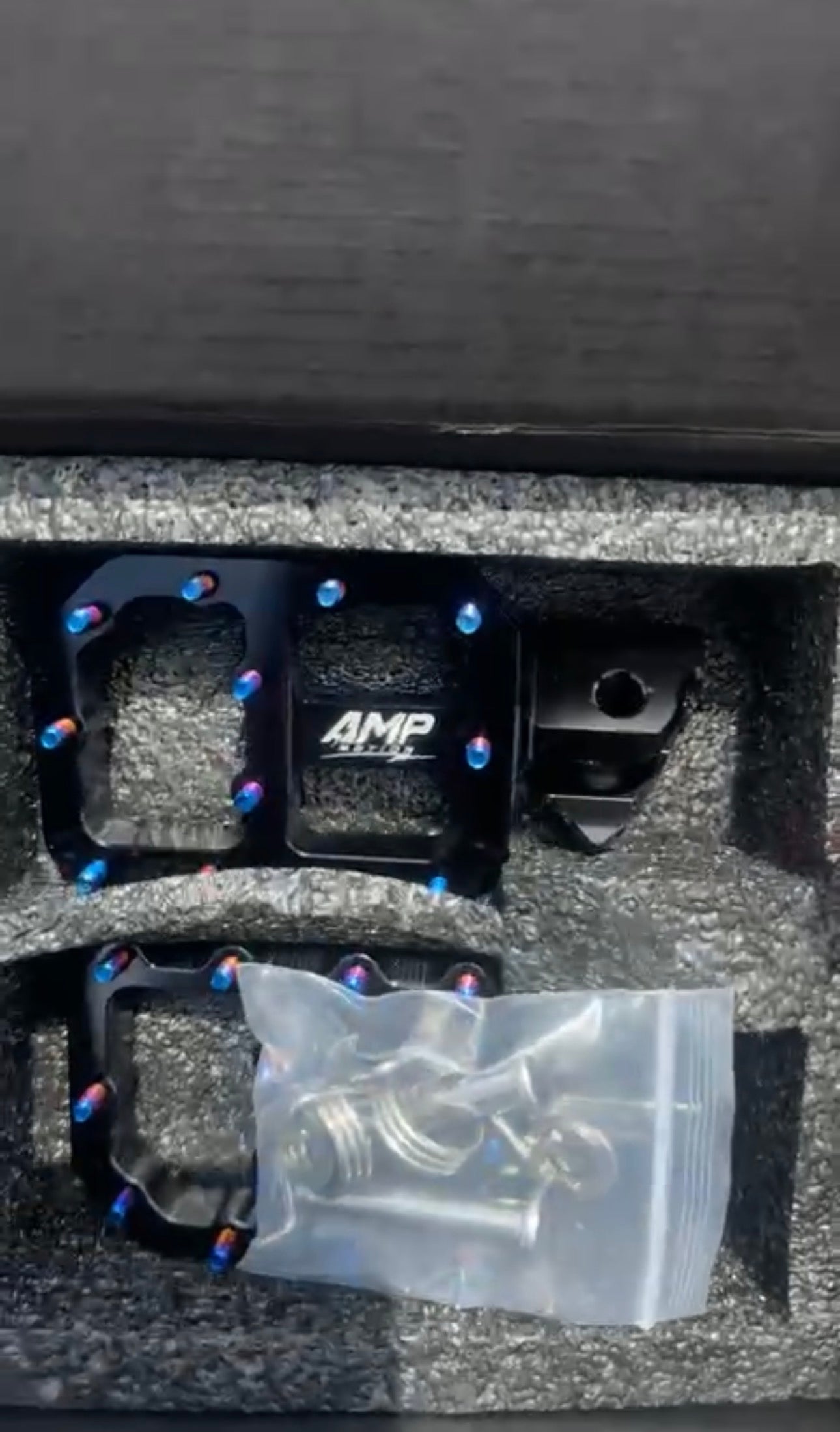 Amp Motion aluminum pegs for bicycles, shown in a full view with a sleek metallic finish and mounting details.