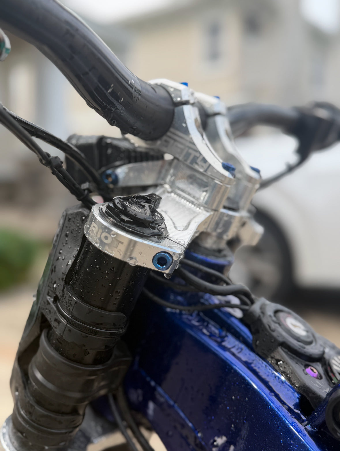 Set of seven DevMoto All Emoto triple clamp titanium bolts, showing the shiny, precision-machined fasteners on a white background.