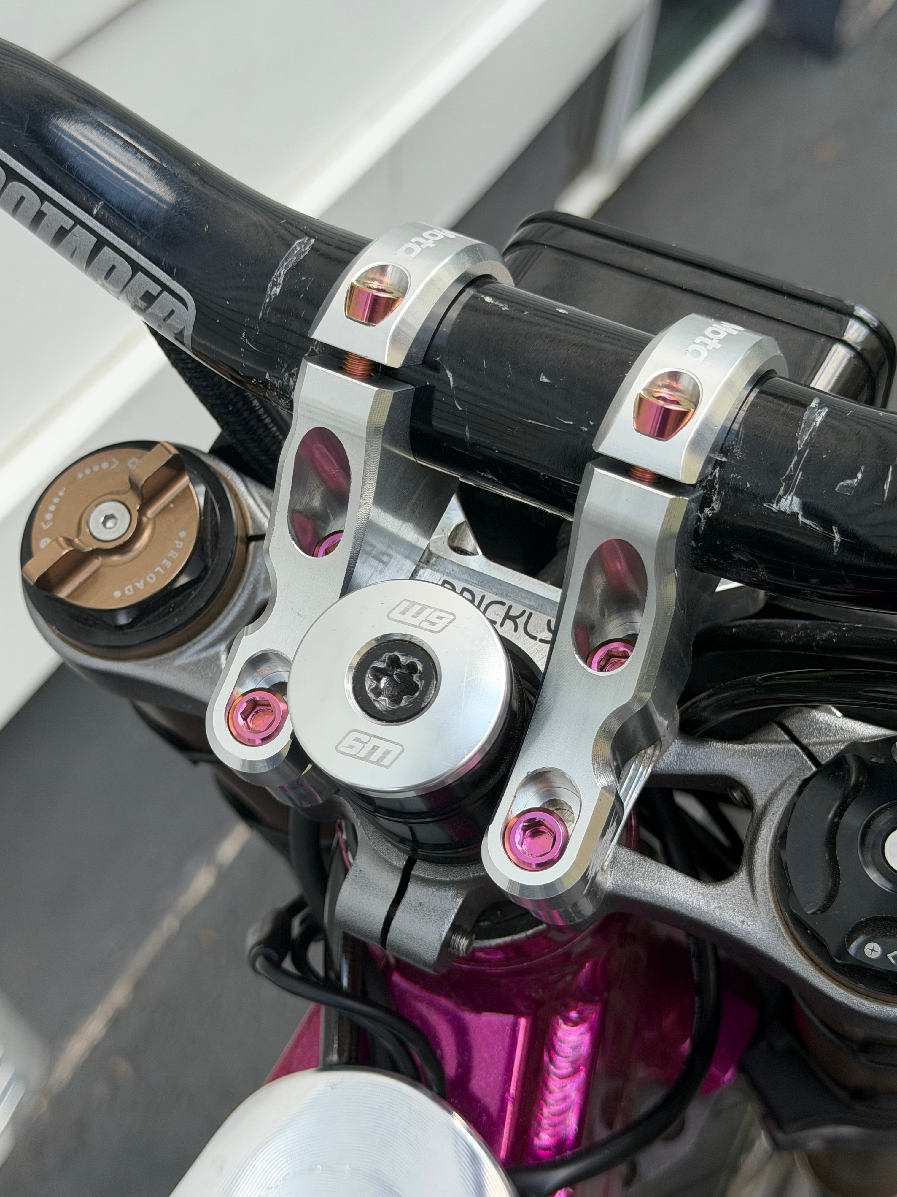 Set of four DevMoto direct mount riser bolts for motorcycle handlebars with threaded ends and hex heads.