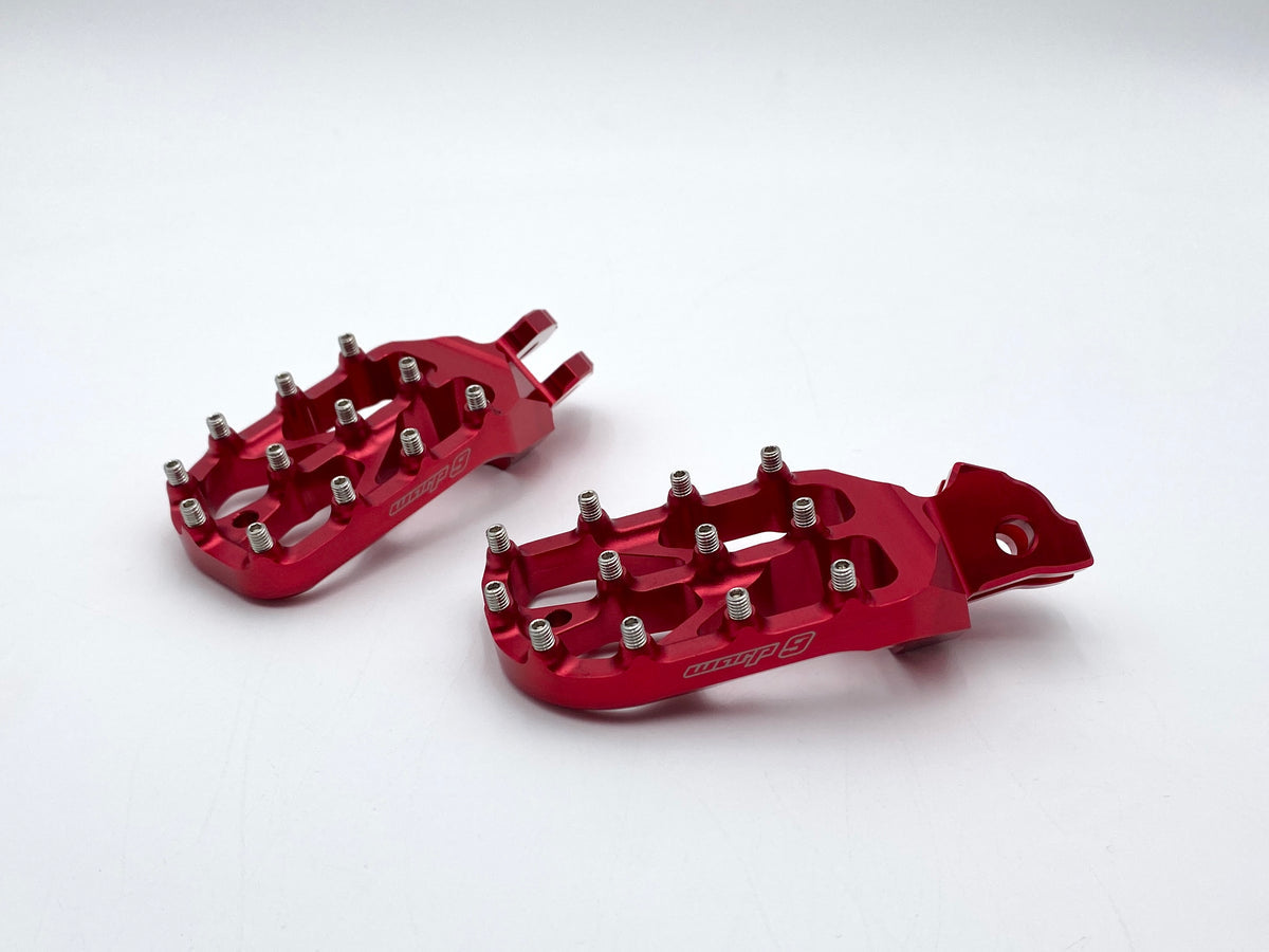 Modded Moto Co Warp 9 Talaria and Sigma Elite foot pegs installed on motorcycle, showcasing durable metal construction and sleek design.