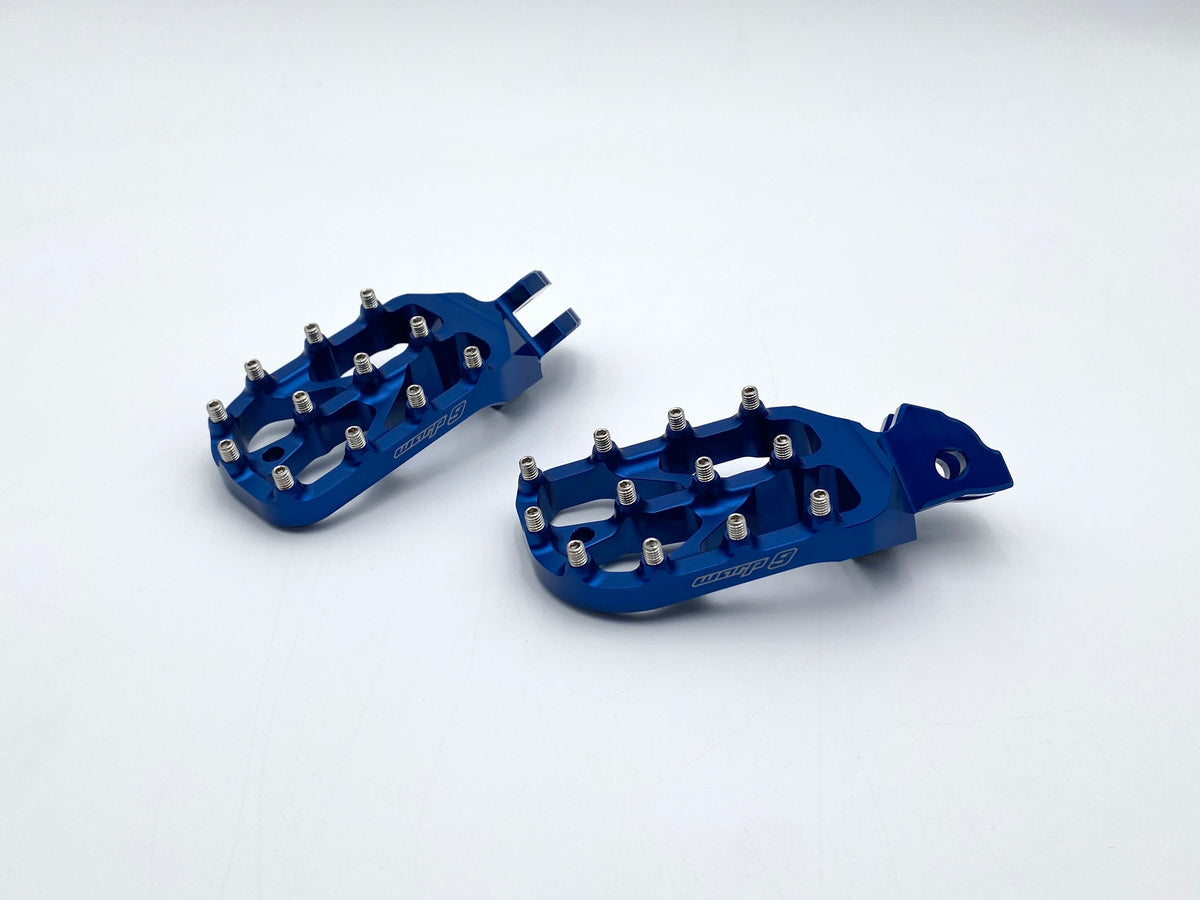 Modded Moto Co Warp 9 Talaria and Sigma Elite foot pegs mounted on a motorcycle for enhanced grip and style.
