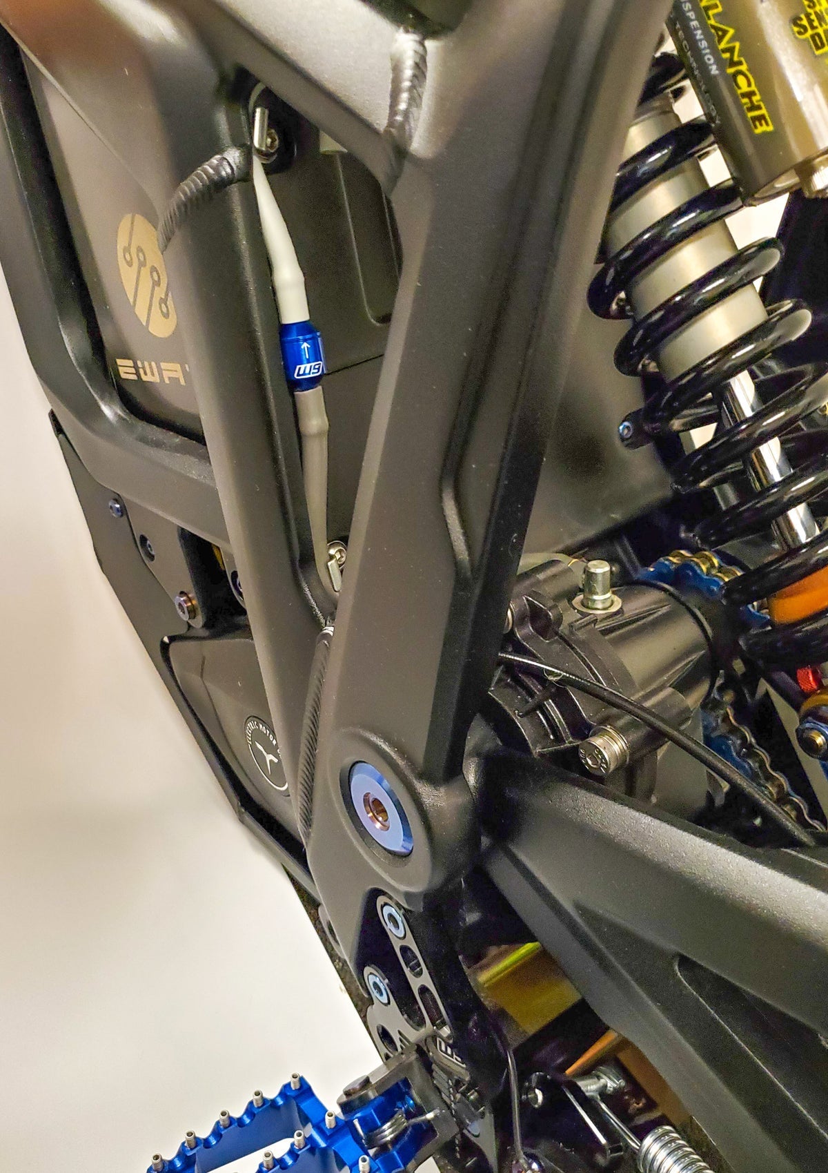 Warp 9 Talaria Sting gearcase vent accessory by Modded Moto Co, showing the vent with mounting details on a motorcycle gearcase.