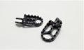 Modded Moto Co Warp 9 Talaria and Sigma foot pegs for motorcycle, durable metal construction with textured grip surfaces.