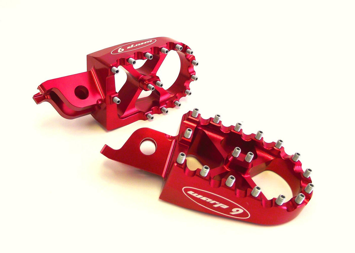Modded Moto Co Warp 9 Talaria and Sigma foot pegs mounted on motorcycle for enhanced grip and stability.