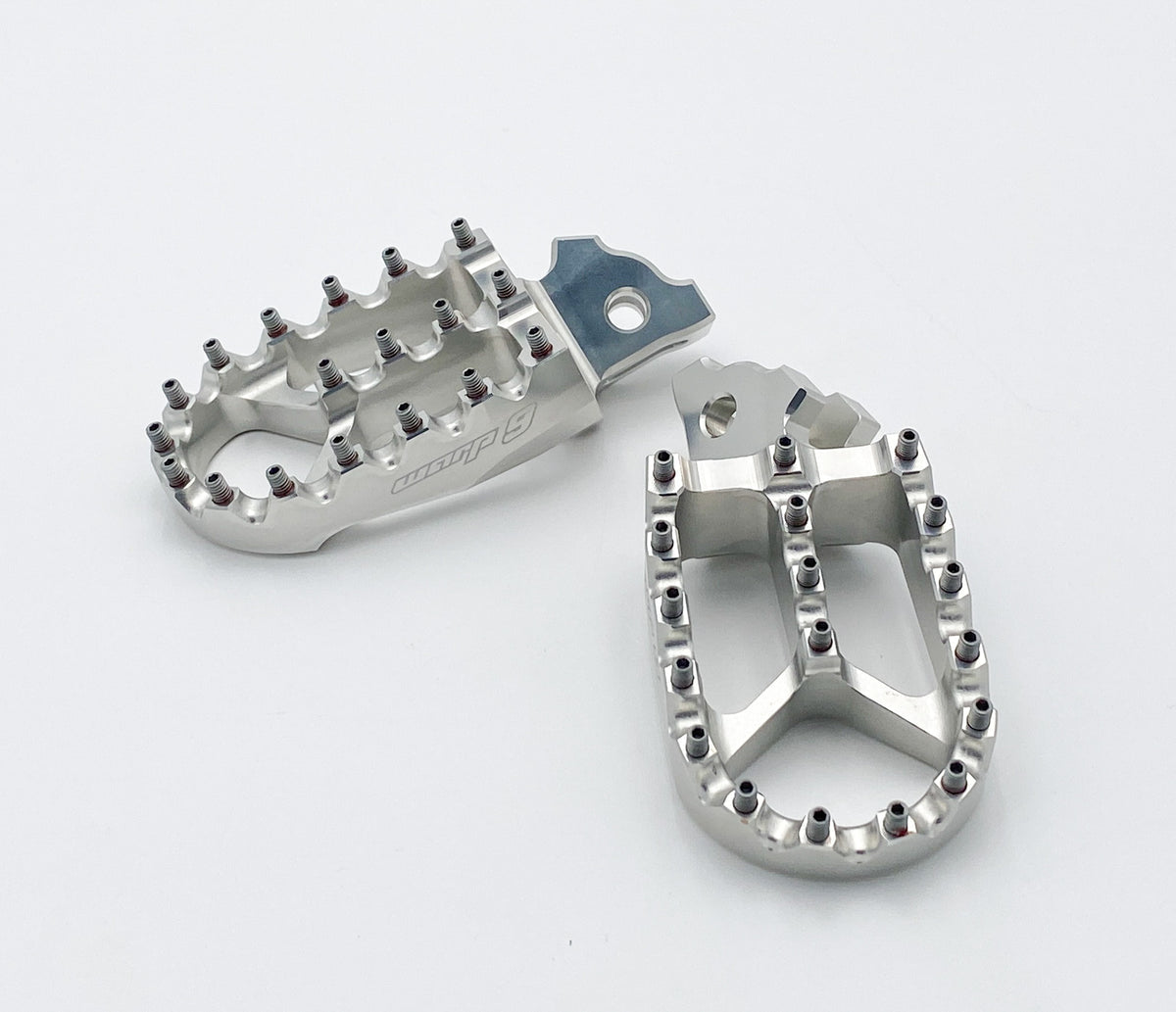 Modded Moto Co Warp 9 Talaria and Sigma foot pegs installed on motorcycle, showcasing durable metal construction and sleek design.